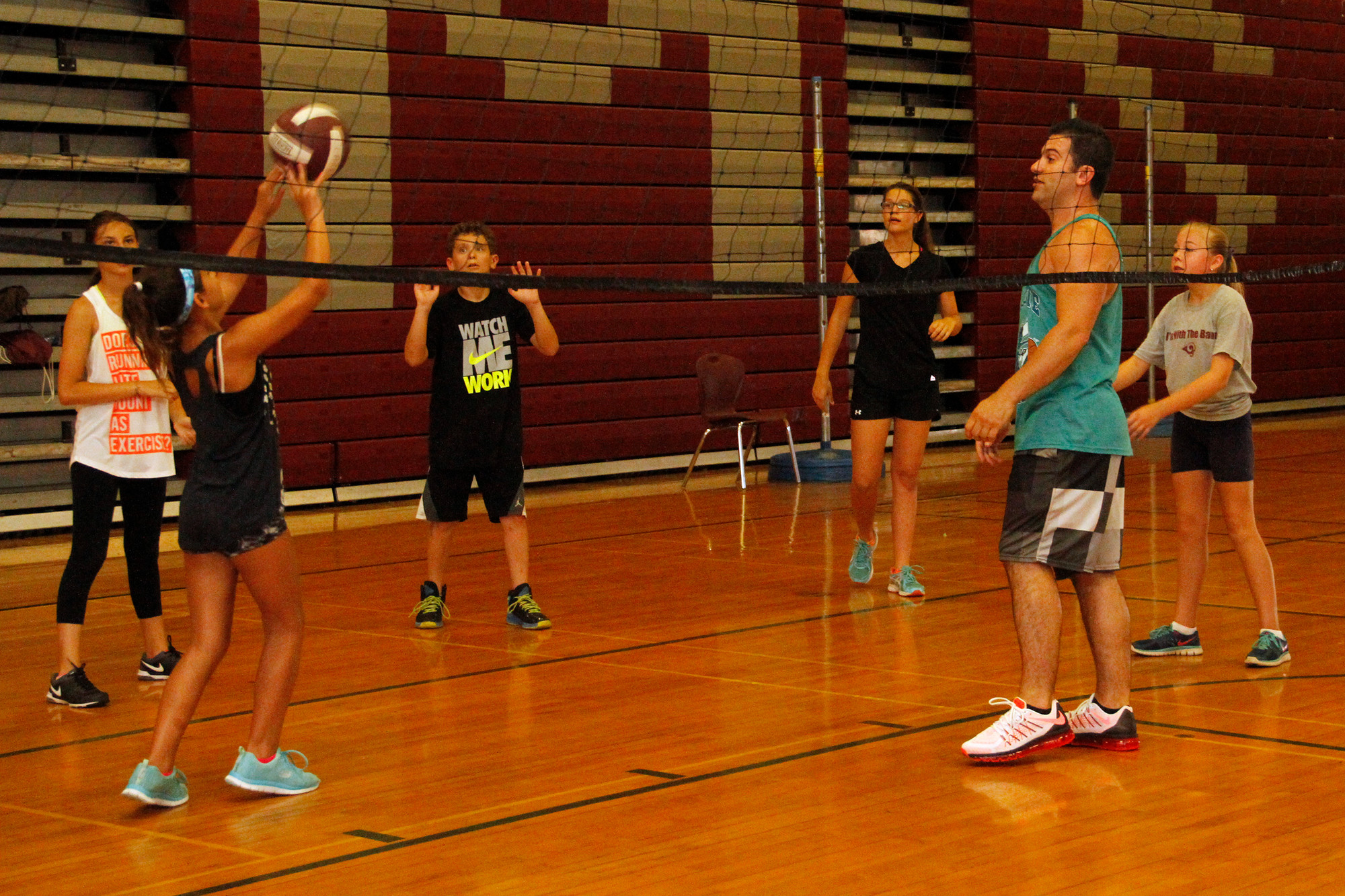 Volleyball coach Chris Tracarico, far right, showed students the proper form for hitting the ball.