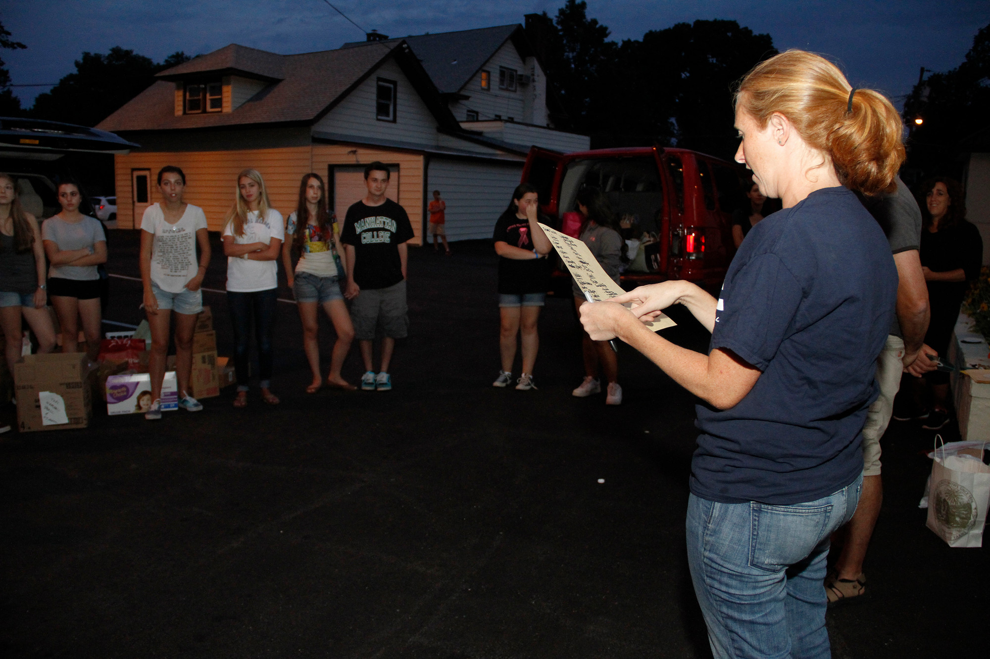 Linda Baldacchino, the Youth Ministry Director at Our Lady of Lourdes, gives out car assignments.