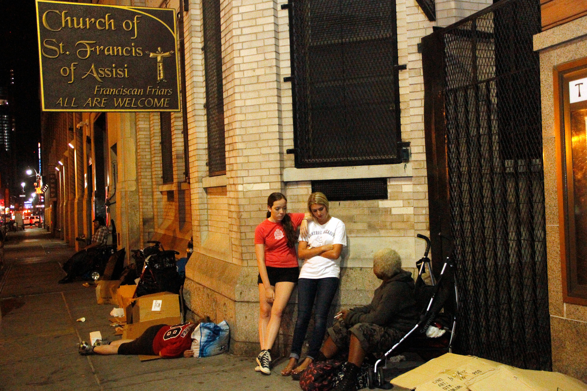 Malvernites Laura Fewer, left, and Sophie Wilson spent time talking with Jean outside the Church of St. Francis of Assisi on 31st St. in Manhattan — the spot that Jean calls home.