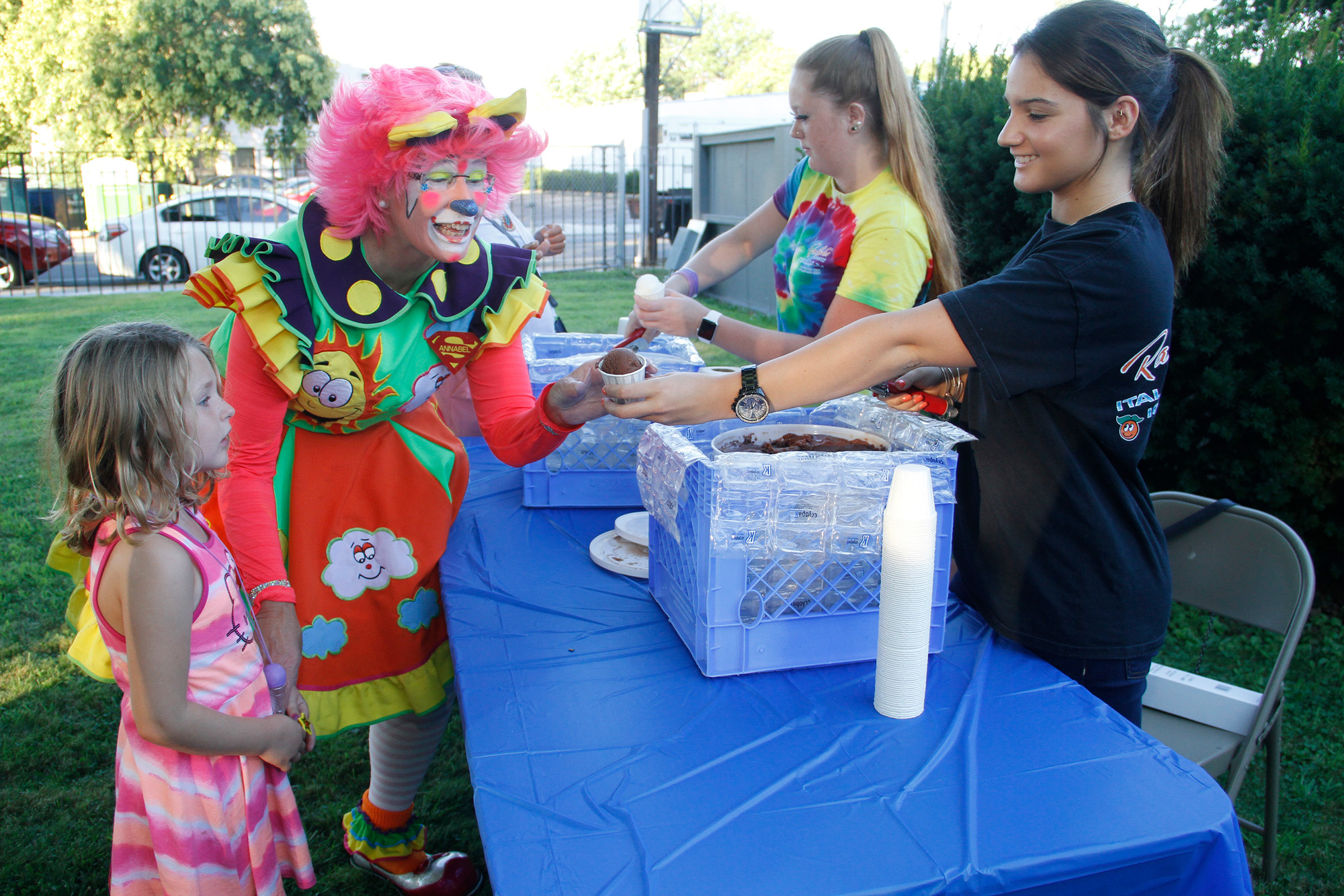 Gabriella Fuschetto, of Ralph’s Italian Ices, handed a chocolate ice to Annabel the clown and Zoey Rotolo at National Night Out on Aug. 4.