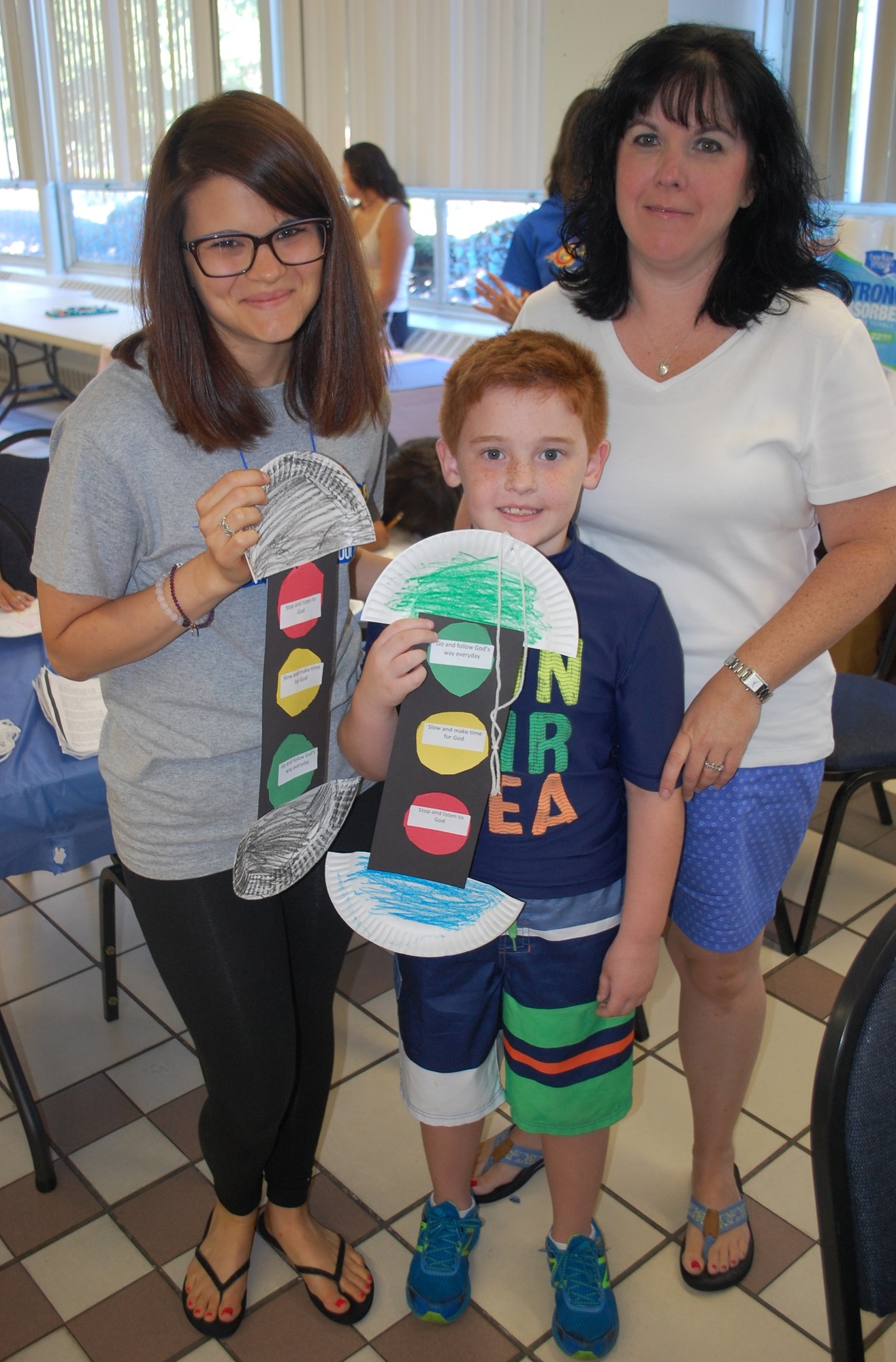 Arts and crafts director Michele Patti, left, with Matthew, 7, and Kim Rackley.