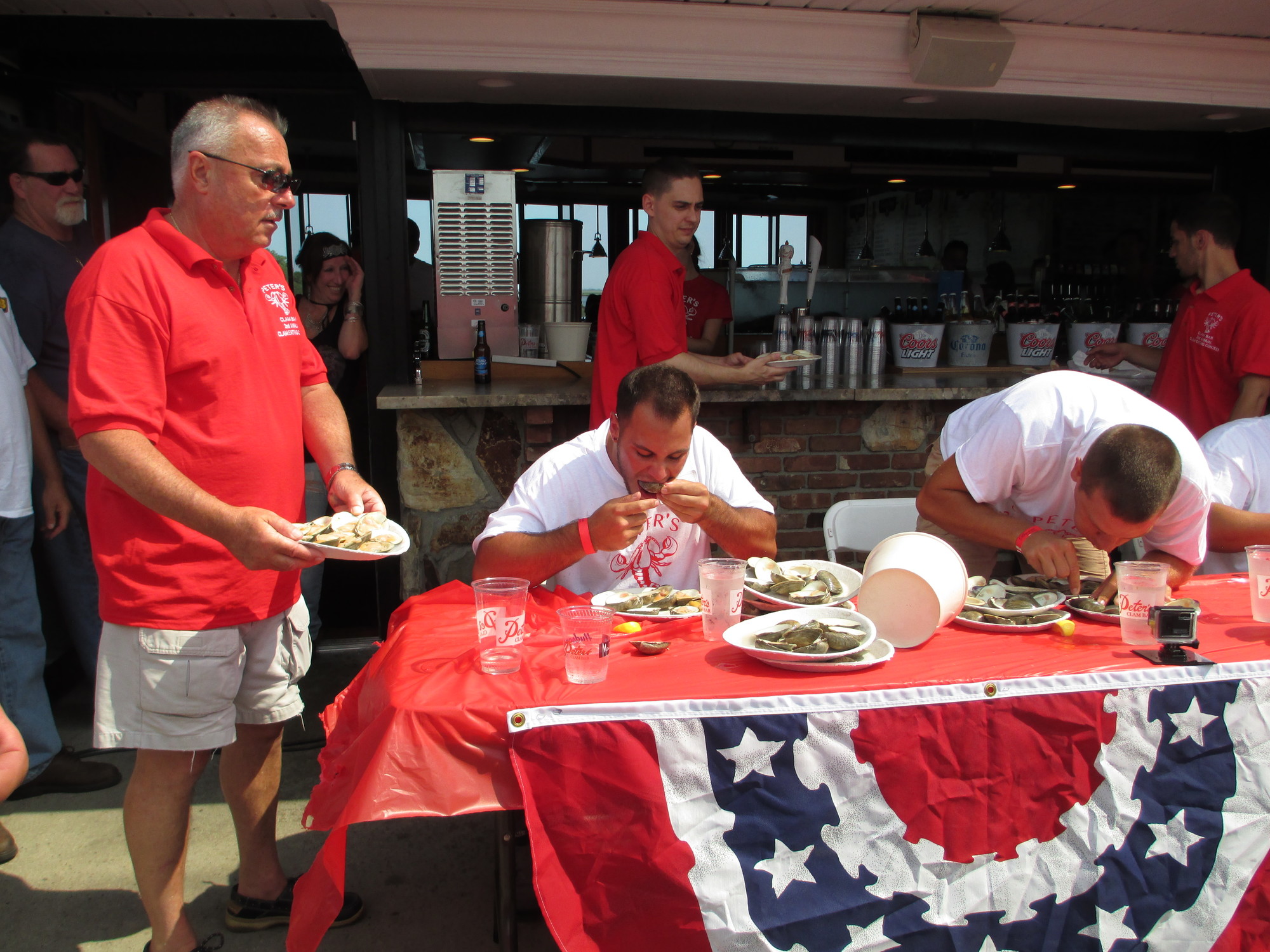 Island Park Deputy Mayor Steve D’Esposito helps restock as eating begins.