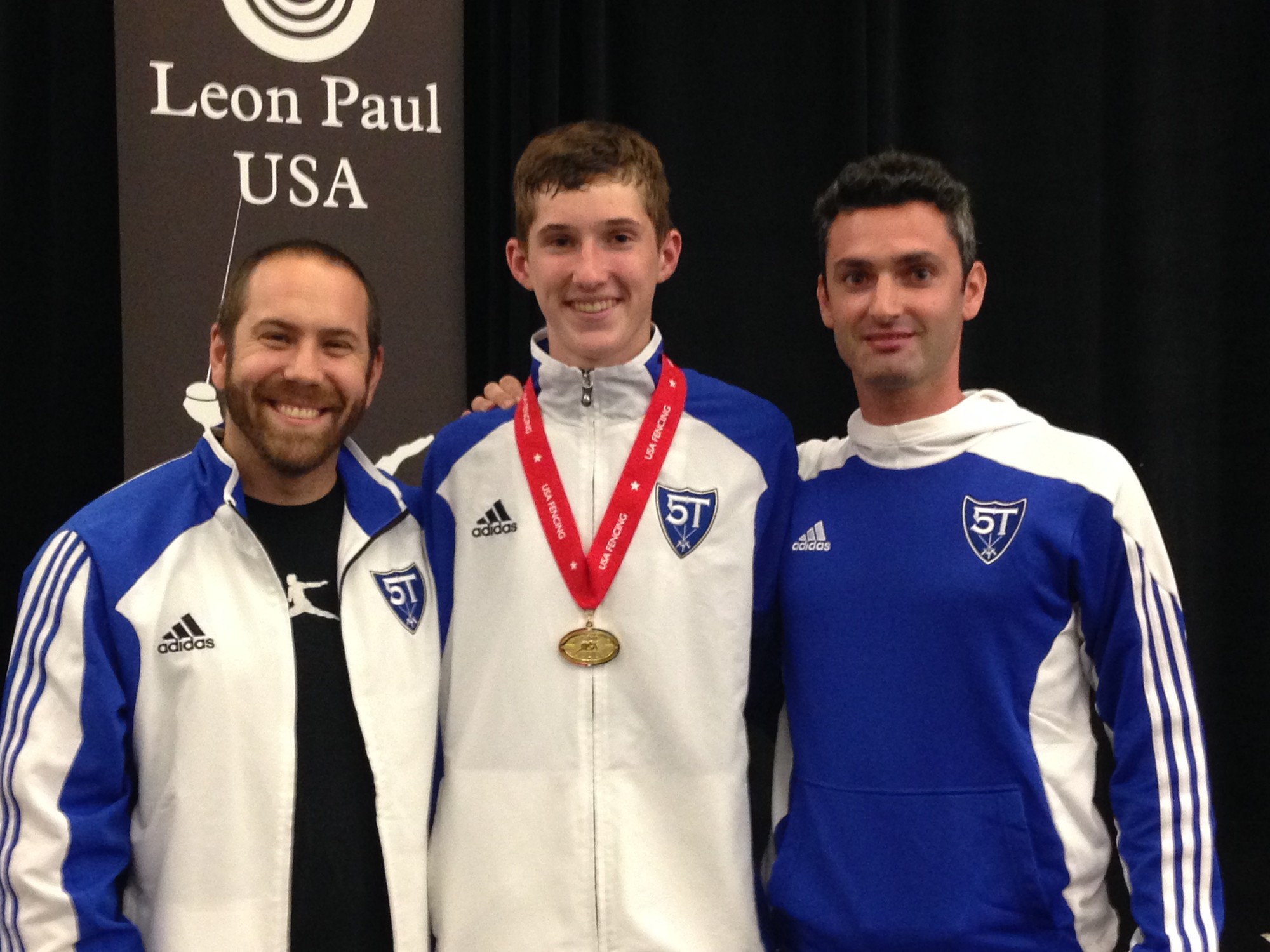 Andrew Machovec, center, with coaches Jonathan Tiomkin, left, and Gidon Retzkin after his gold-medal win at fencing’s summer nationals in San Jose, Calif., in June. Retzkin, his personal coach, received a coaching medal for Andrew’s win.