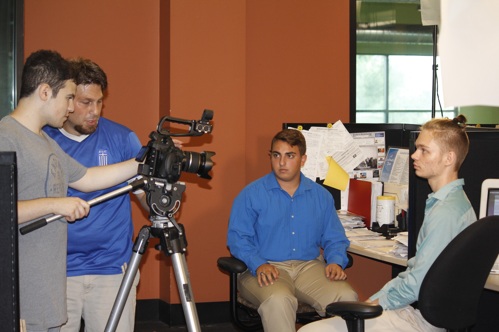 Max Hechtman, far left, and Chris Tsalikis filmed actors Jimmy Gratta and Lucas Iverson inside the Herald offices in Garden City. Both Iverson and Gratta play journalists in the short film.  Photo by Christina Daly/Herald