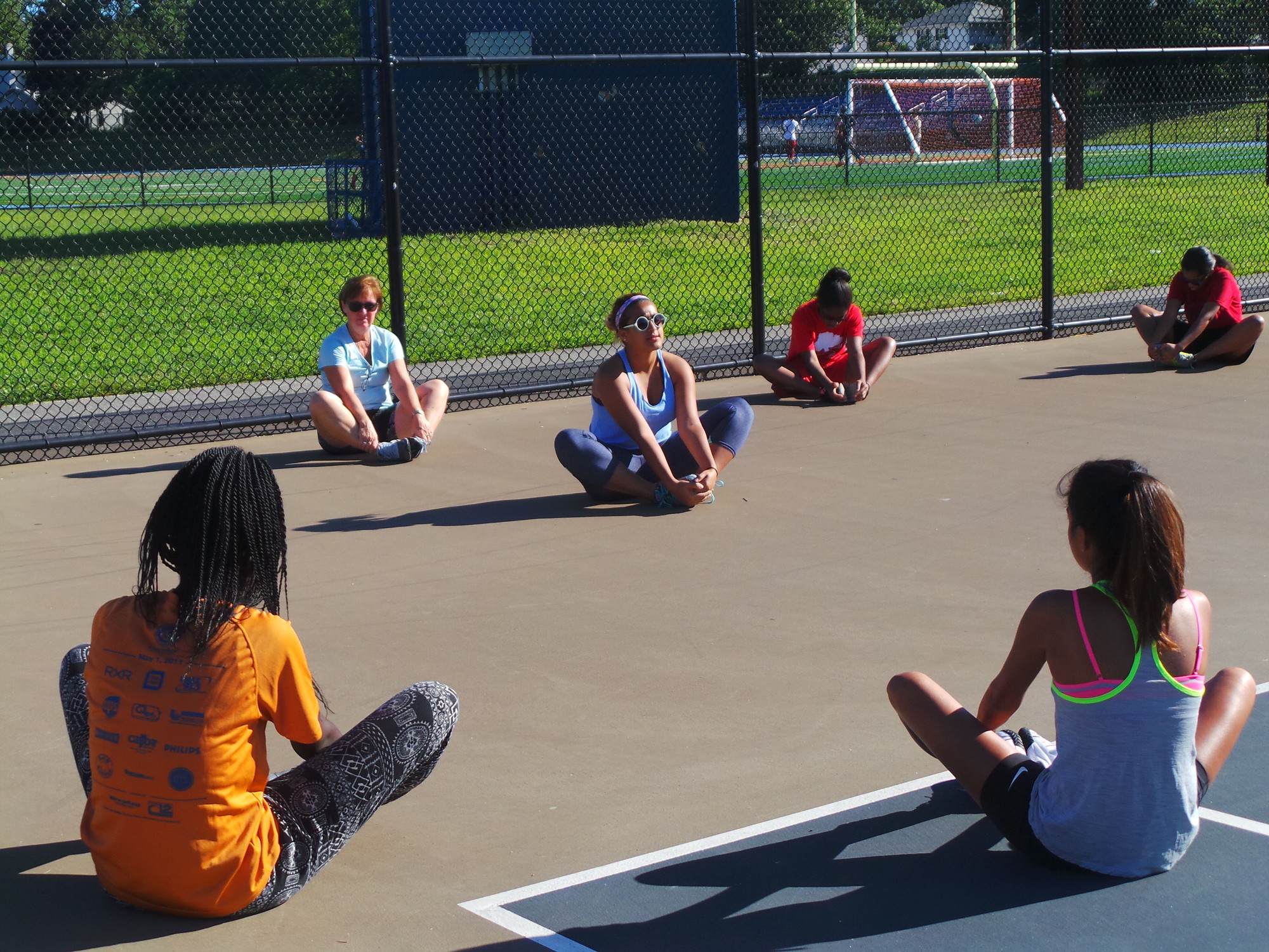 Malverne High School tennis team captain Sarah Afzali, center, led her team in warmup drills prior to a practice on the high school courts last week.