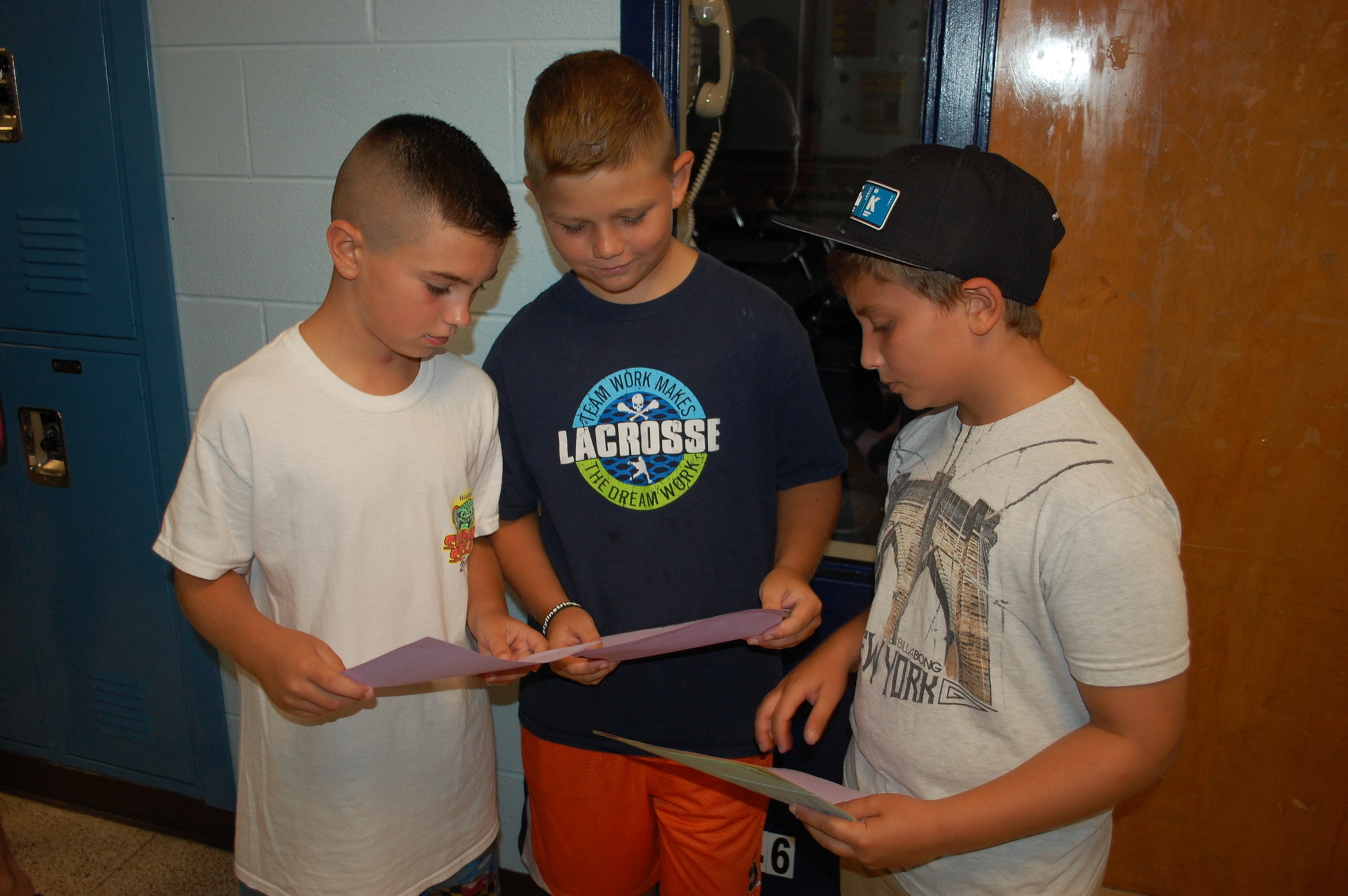 Sixth-grade students Dennis Milashouskas, left, Aidan Kruysman and Michael Matteo compared schedules.