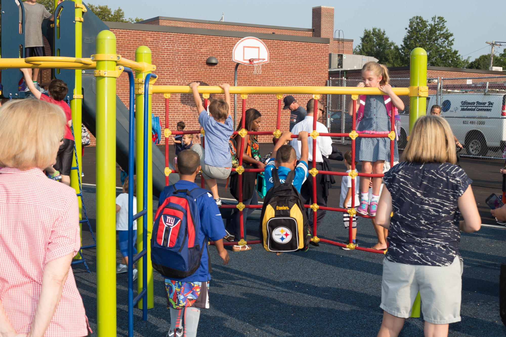 Some students took a moment to try out the school’s new playground equipment before classes started.