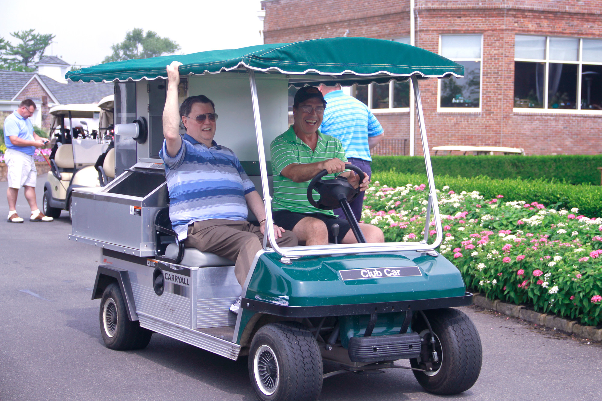 Mayor Hendrick and Deputy Mayor Alan Beach drive the beverage cart.