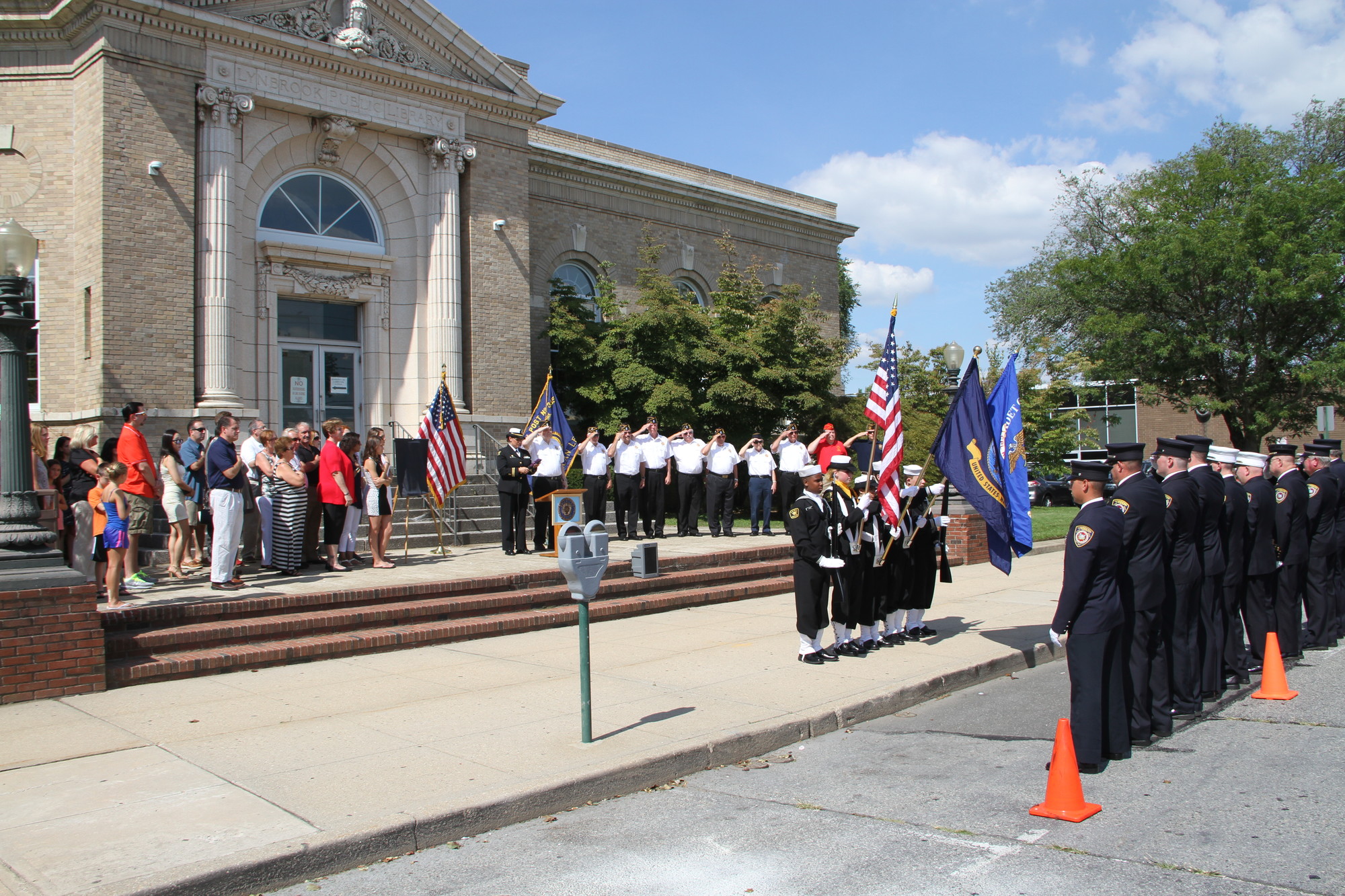 Village officials, family members, residents, American Legion members, Lynbrook Fire Department members and US Naval Sea Cadets took part in a ceremony held on the steps of the Lynbrook Public Library.