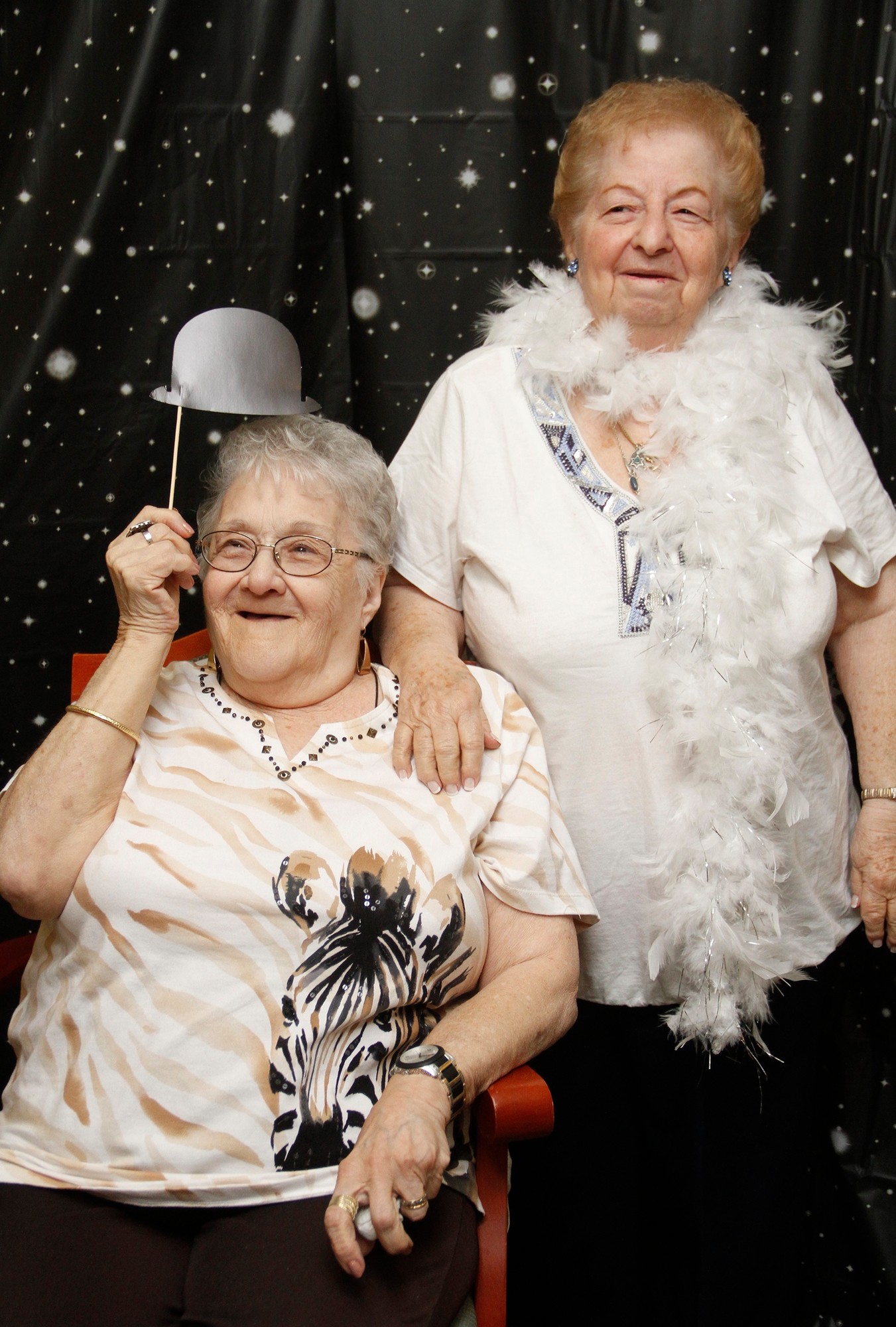 Blanche Epstein and Bernice Lefkowitz took advantage of the photo station and props.