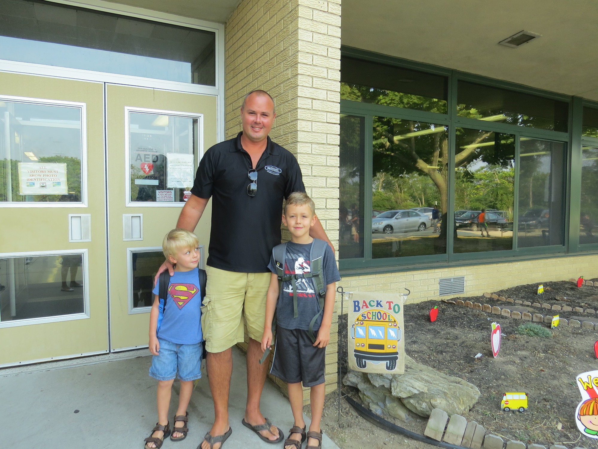 Doug Foote saw his two sons, John, left, a kindergartner, and Michael, a second-grader, off to school at the Harbor School.