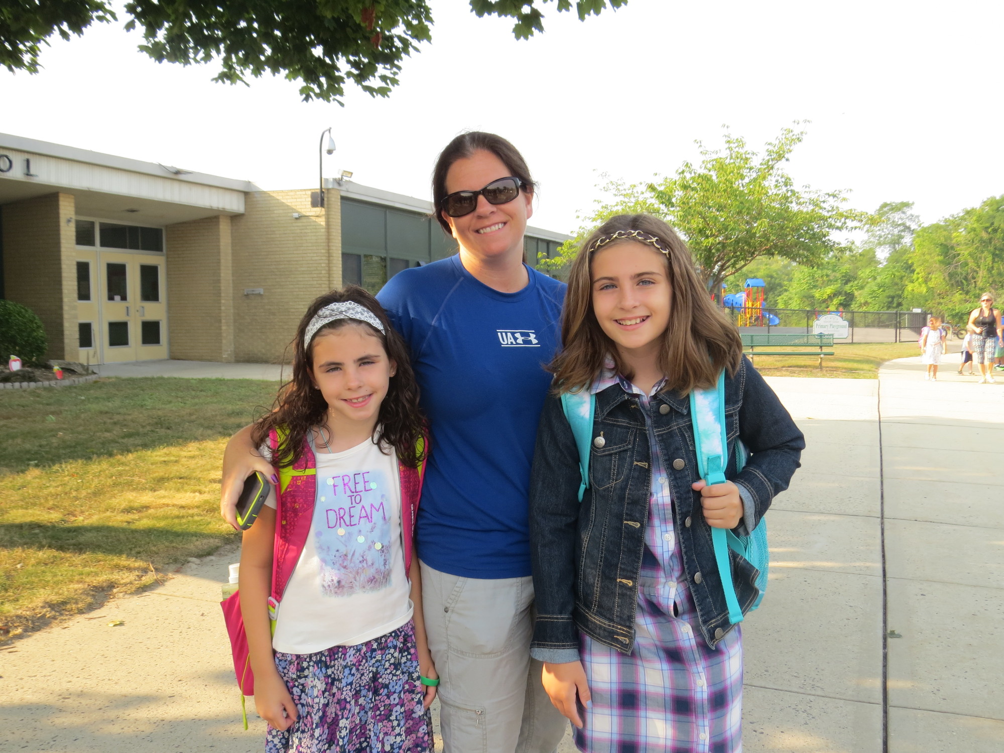 Meghan Nocera wished her daughters Ryleigh, left, a second-grader, and Kailly, a fifth-grader, a good first day at Seaford Harbor School.