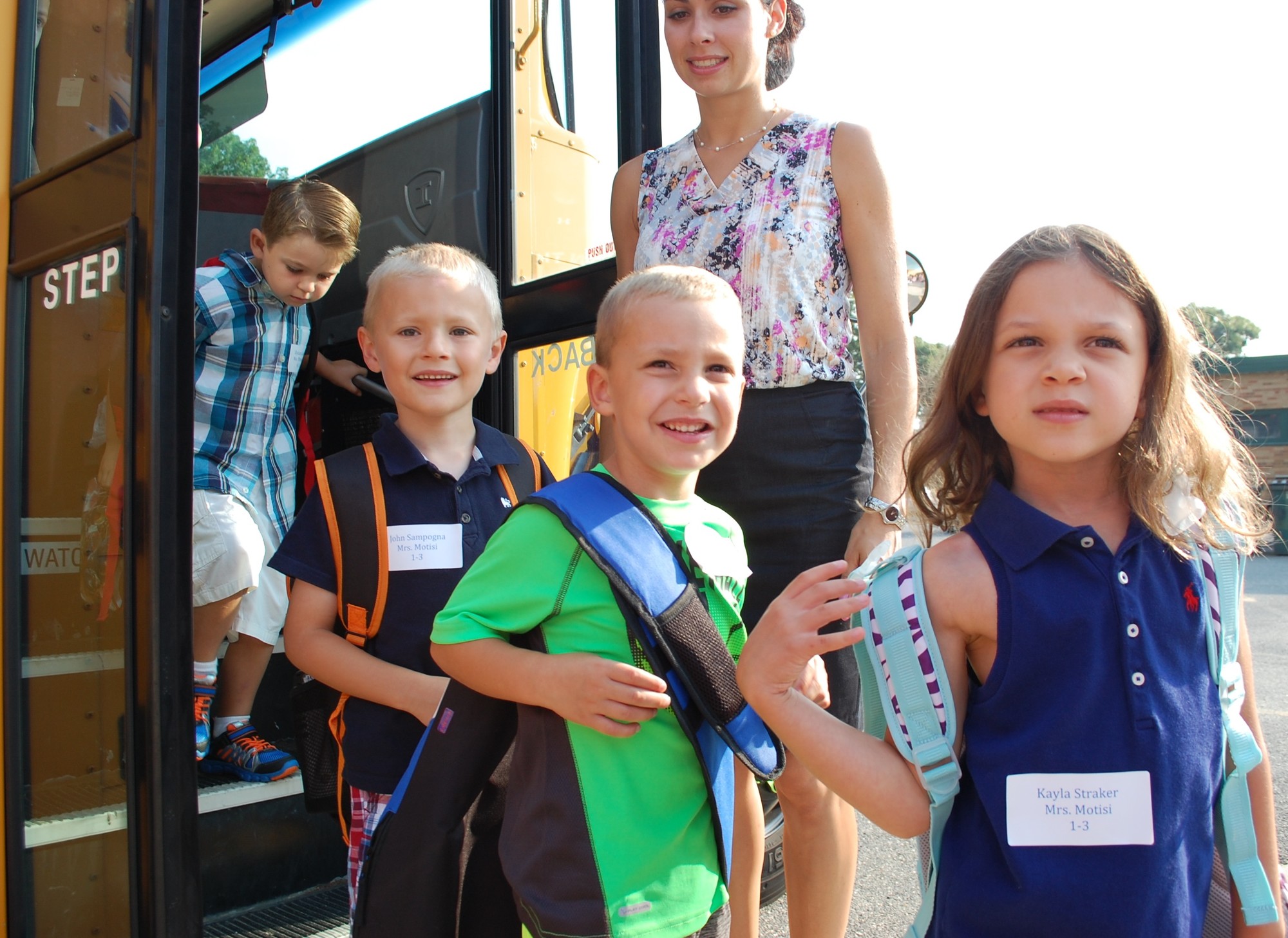 Young Seaford Manor School students, from left, Dylan Lukas, John Sampogna, Michael Calvacca and Kayla Straker arrived for their first day of school on Sept. 3 under the watchful eye of teacher Mariana Beach.
