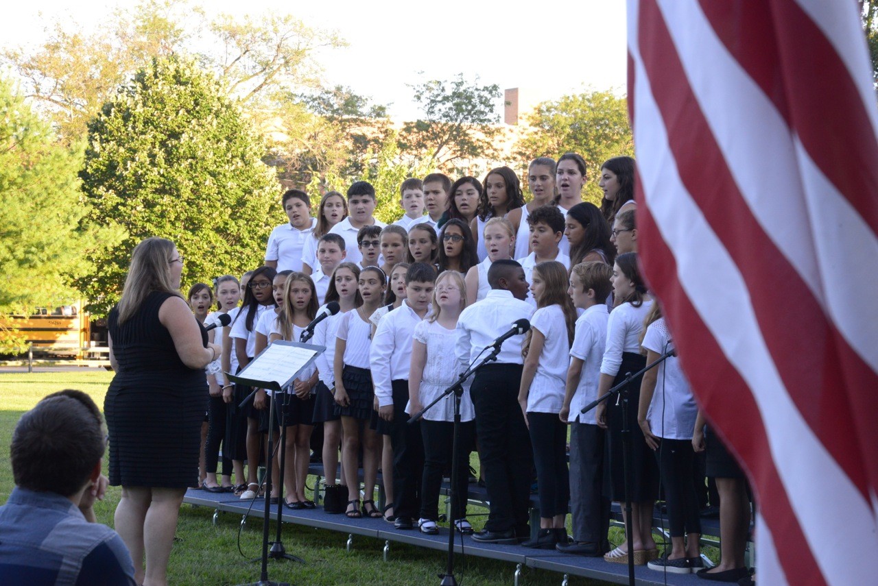 Erin Deegan led the School 9E chorus as they sang "A Song of Peace" by Teresa Jennings.