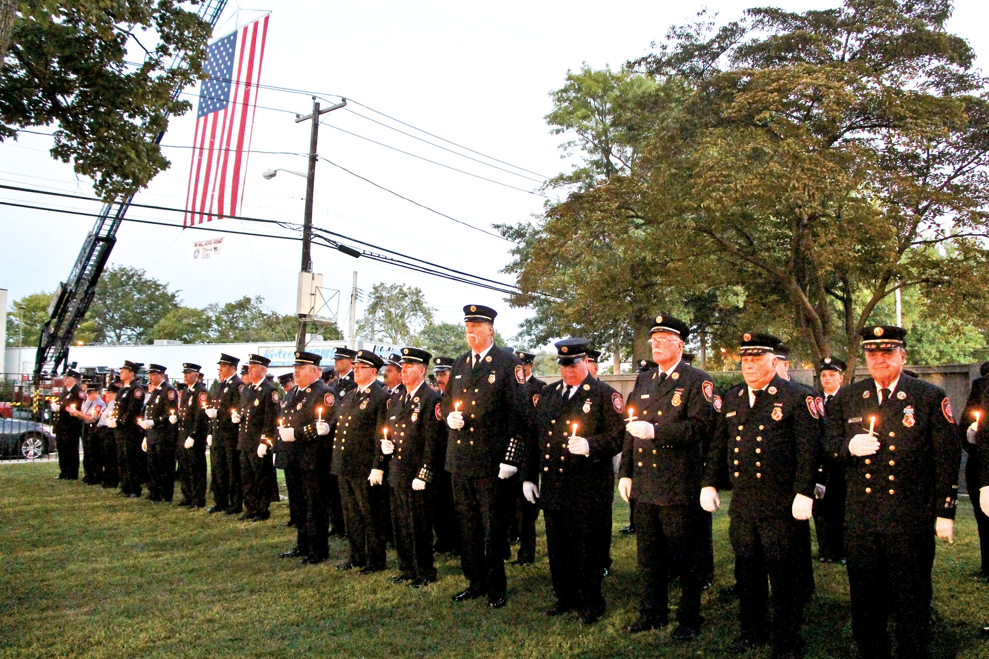 A candlelight vigil hosted by the East Meadow Fire Department last Friday in Veterans Memorial Park marked the 14th anniversary of the Sept. 11 World Trade Center attacks. Some 300 residents joined the department to pay their respects.