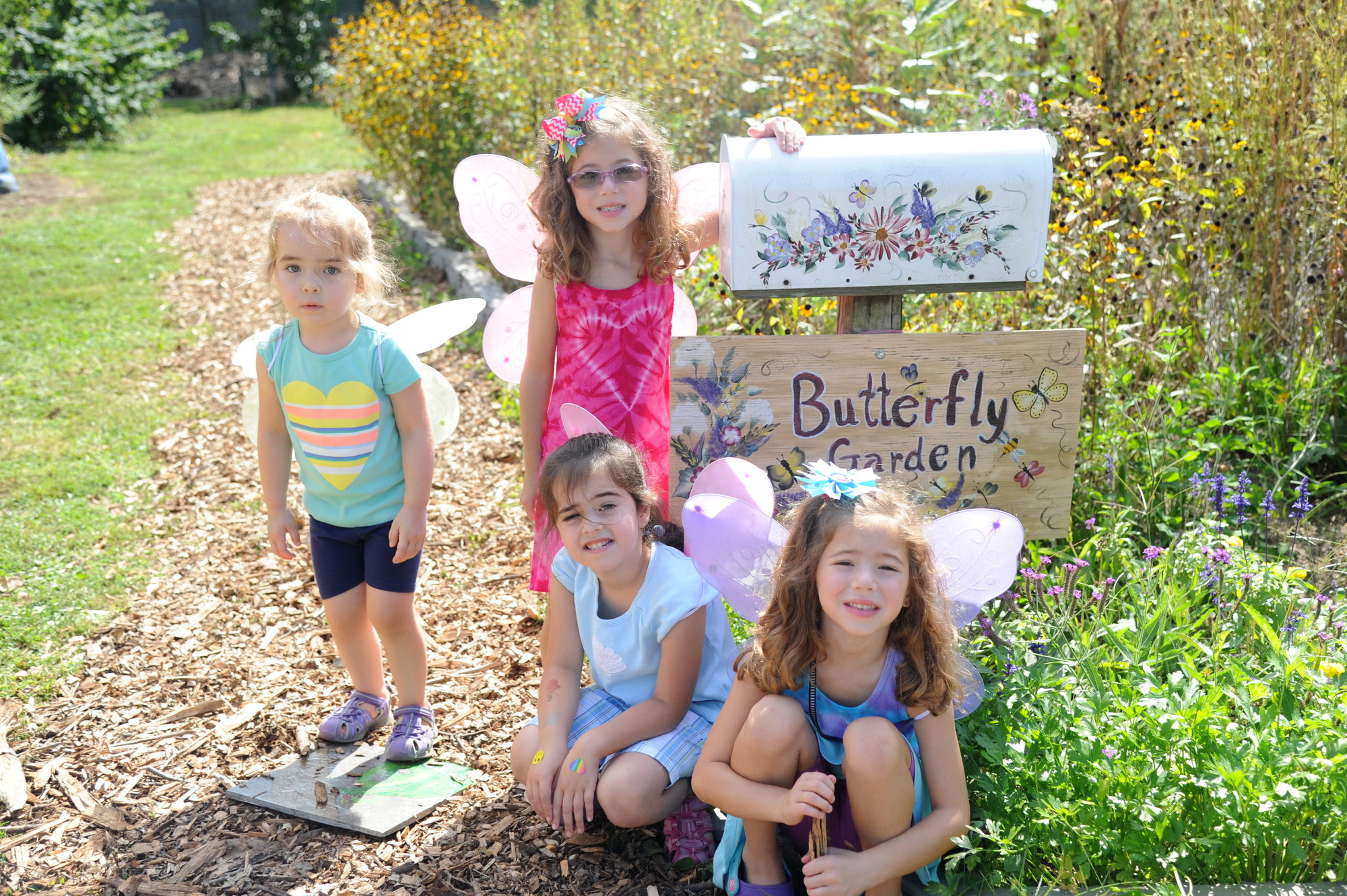 Adorned in butterfly wings were cousins Mia Saputo, 3, Lilly Turner, 6,  Rylie Sena, 5, and Sophie Turner, 6, all of North Merrick, next to the farm’s butterfly garden.