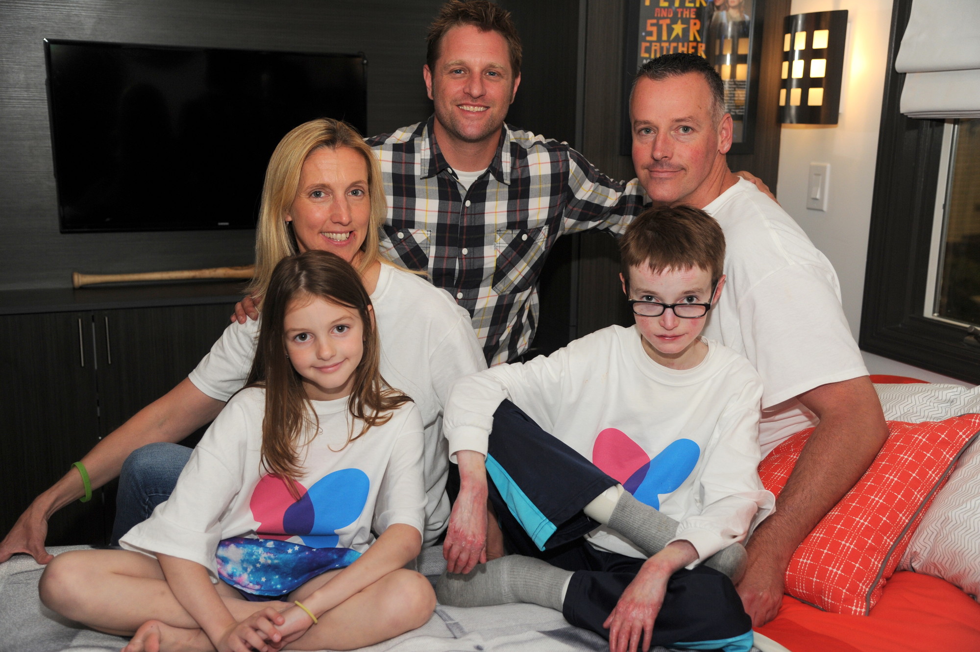 Seated on his new bed last June were Robbie; his sister, Allison; their parents, Kathy and Robert; and “George to the Rescue” host George Oliphant. An episode of “NBC’s George to the Rescue,” featuring the family, will air this weekend.
