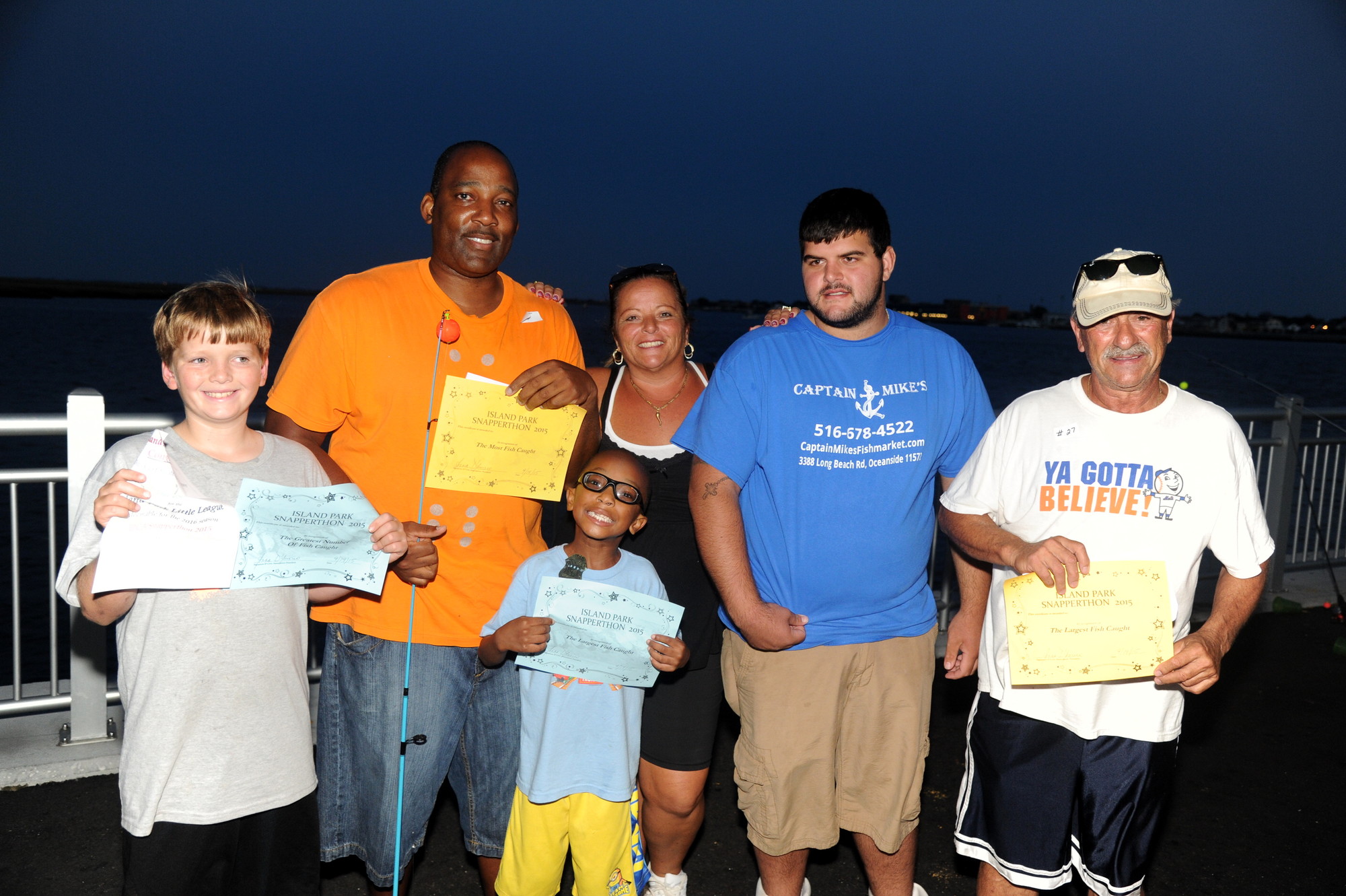 Winners Jonathan Schurin  (10 years old), Craig and C J Graham (6 years old), Dominica Califano of the of the IPCA, Mike Spina of Captain Mike’s Seafood and winner Vinny Disalvo.