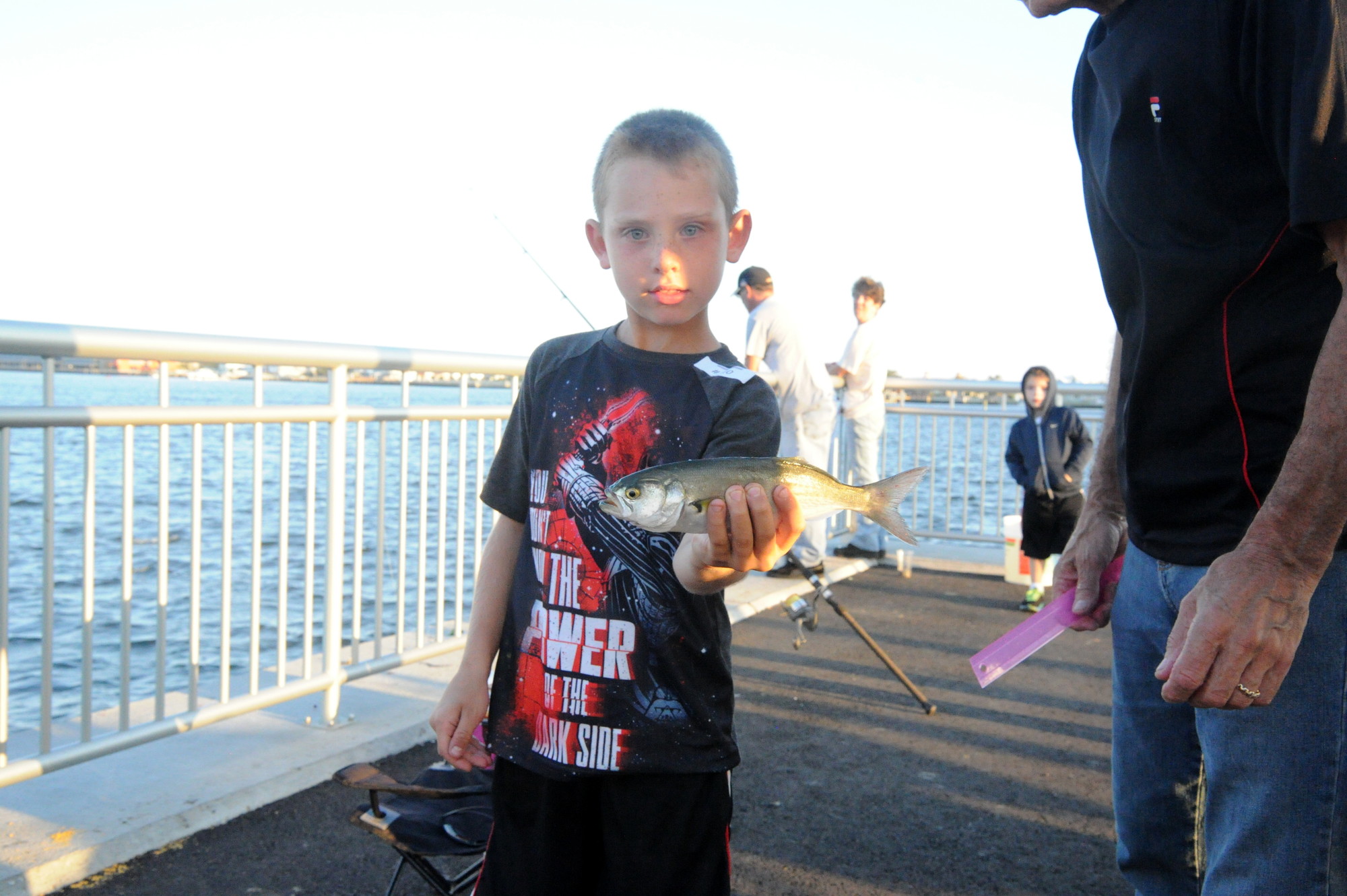 Andrew Livingston (age 8) shows his catch before he tossed it back in.