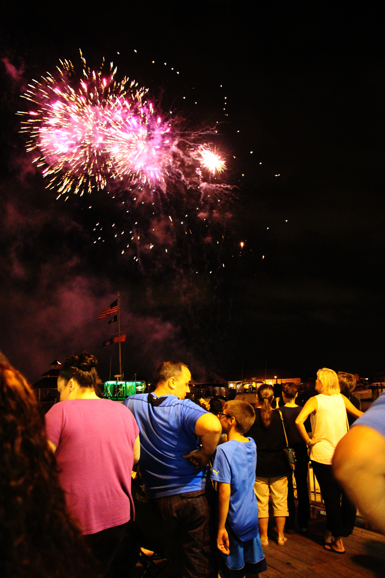 The crowds gathered at the shoreline of the canal to see the colorful fireworks.