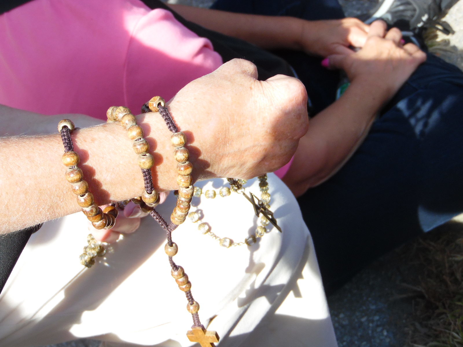 A woman prayed with her rosary beads.