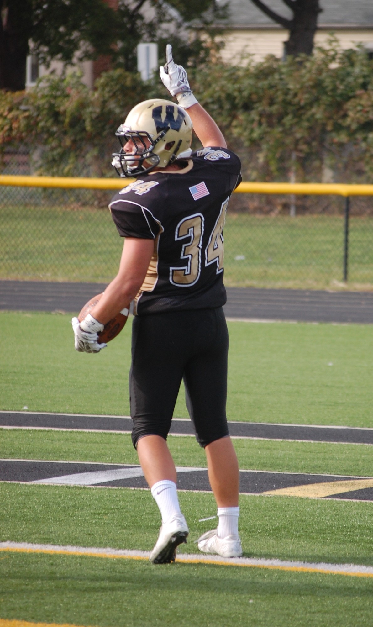 Kyle Sliwak celebrates after scoring a touchdown in the Warriors 27-0 win.