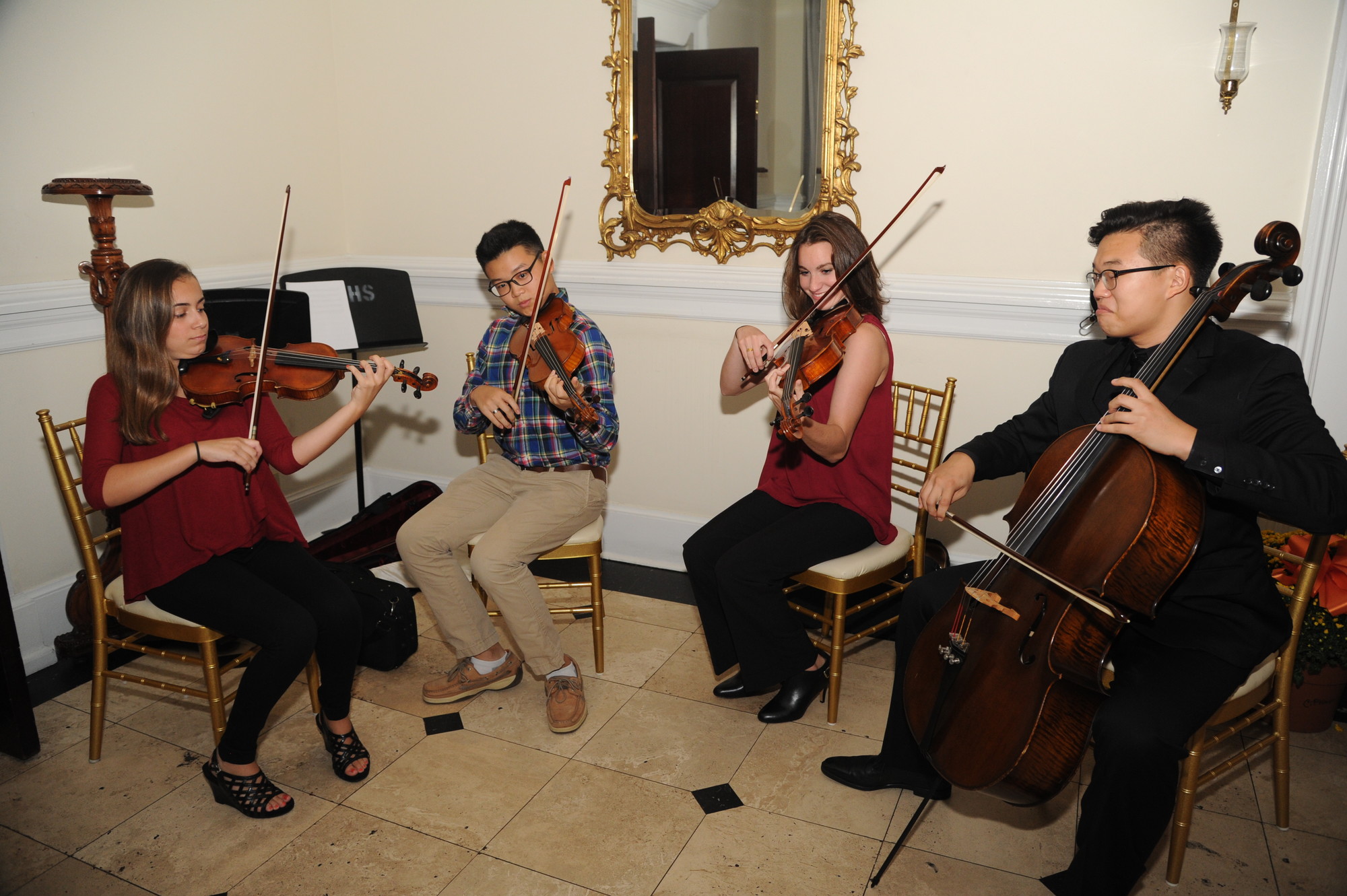 Jolie Rebelo, Edward Park, Alyssa Bydzynski and David Kim, left to right, of the East Meadow High School’s string quartet, serenaded attendees.