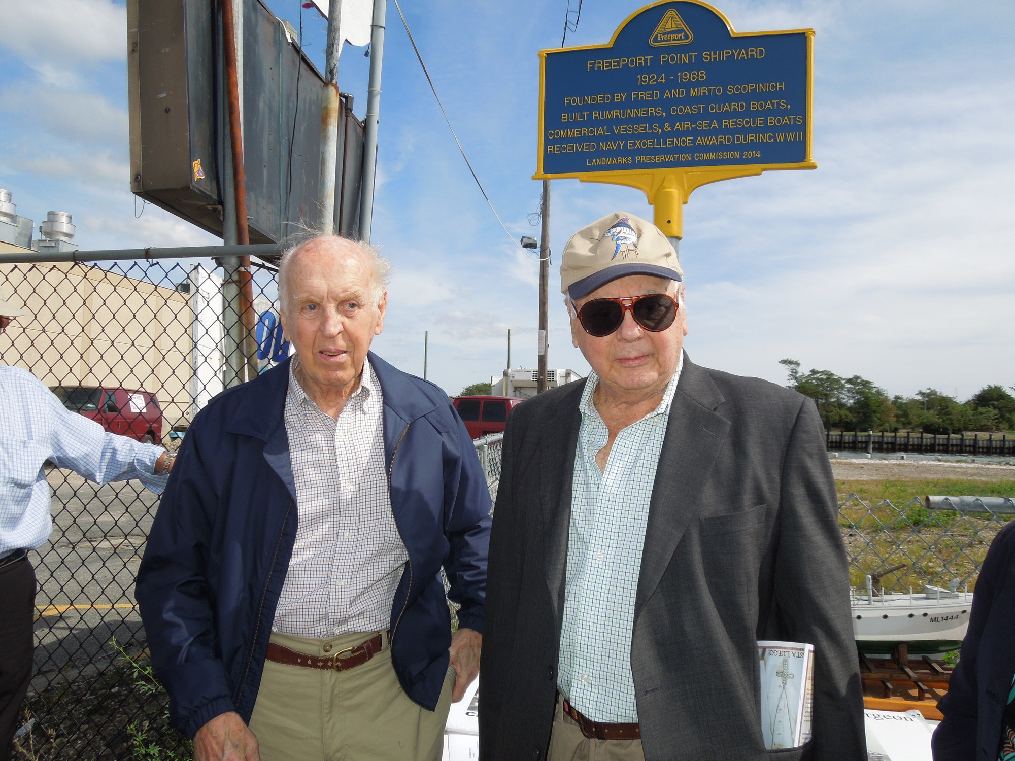 Mario and fred Scopinich unveil a marker that honors the Freeport Point Shipyard, founded by their family.