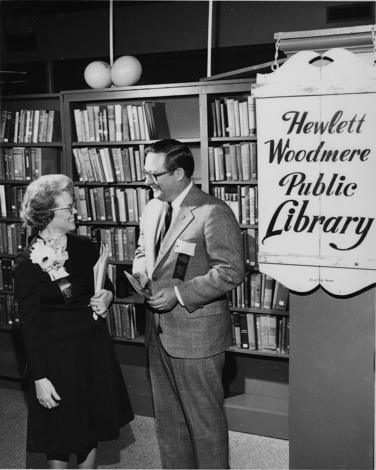 The wood sign created by Joseph Burg Sr. is at right. The library’s first director, Elizabeth Thomson with Congressman John W. Wydler in 1973.