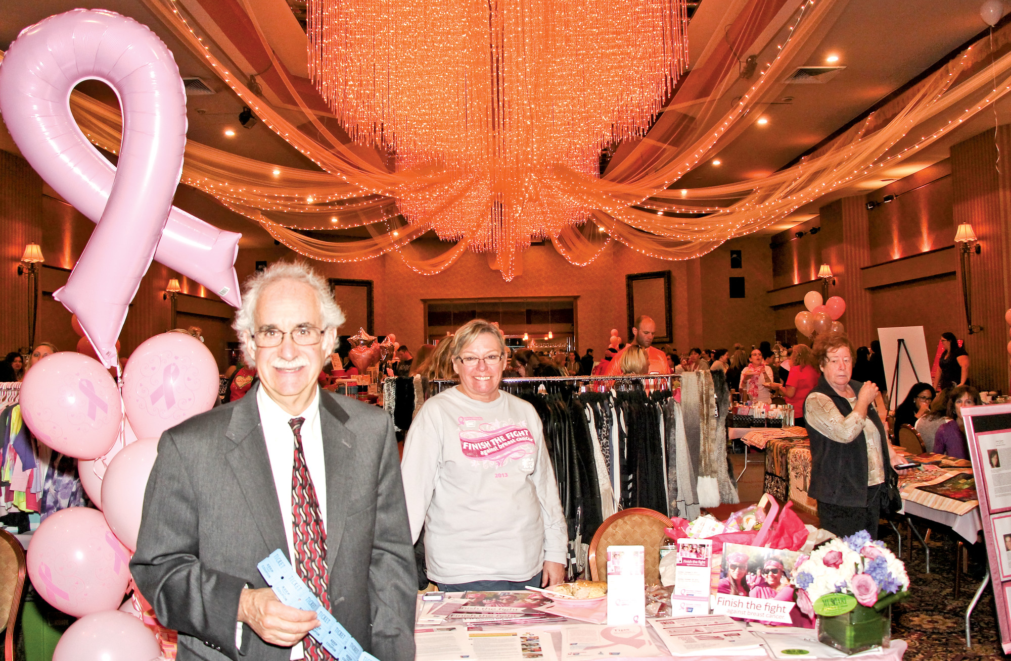 Rabbi Ronald Androphy of the East Meadow Jewish Center purchased a raffle ticket from Pam Cartledge, a 10-year breast cancer survivor and volunteer for the American Cancer Society.