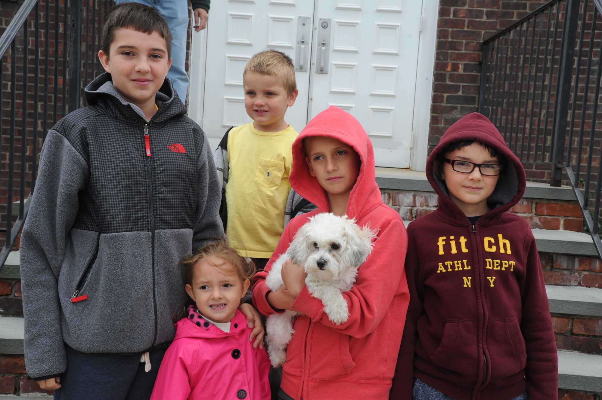 Mateusz Pienkowski, 13, far left, Olivia Pienkowski, 4, Robert Koterba, 5, Adam Koterba, 9, holding Dolly, and Jakub Poenkowski, 9, were not deterred by the rain.