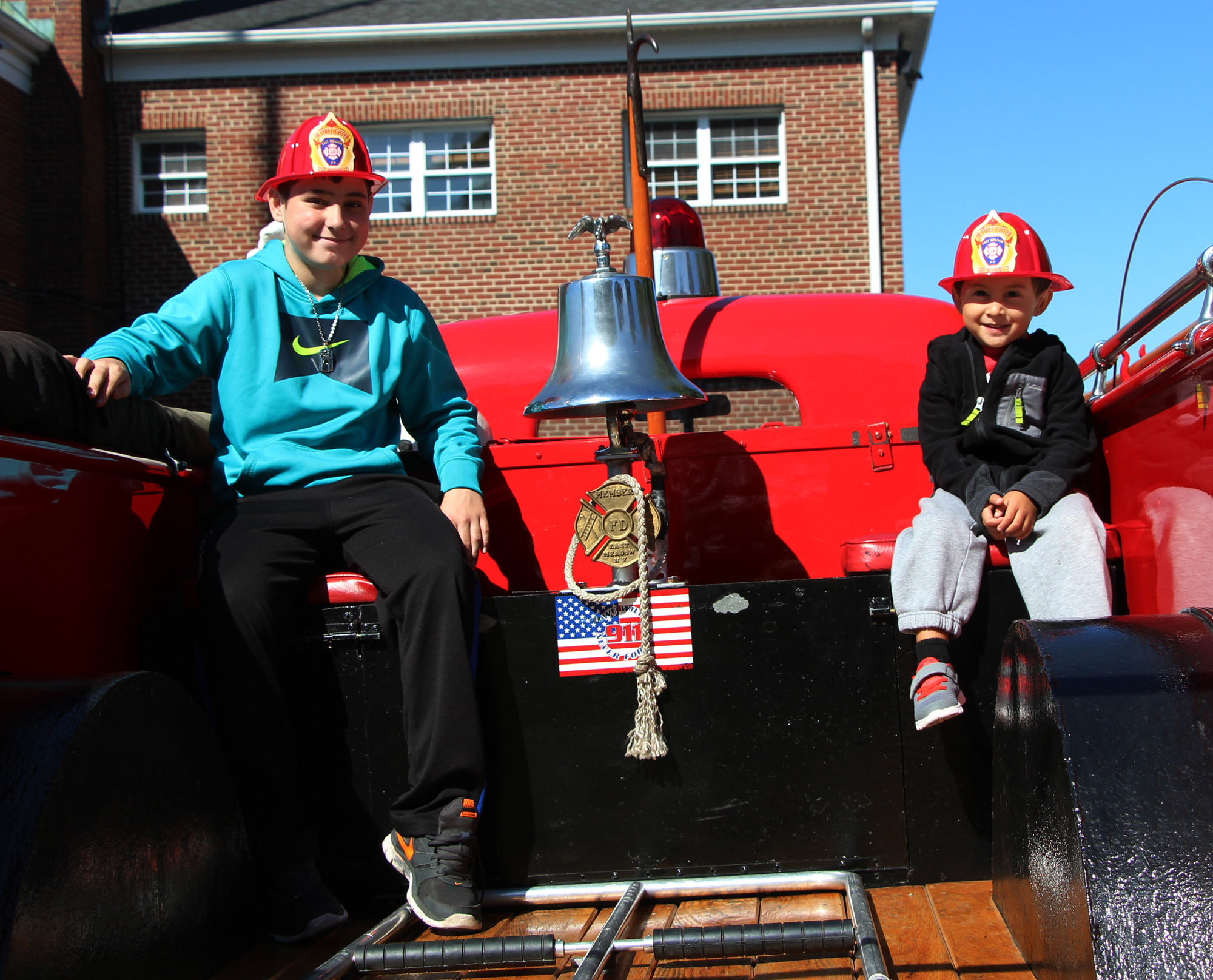 Antonio Bosotino, 12, and Christian Griparic, 4, atop an East Meadow fire truck, were all smiles.