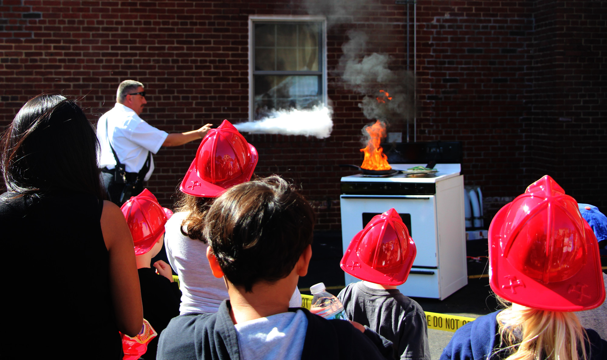 Kids and parents watched Chief James Kane demonstrate fire preventive techniques for the kitchen stove.