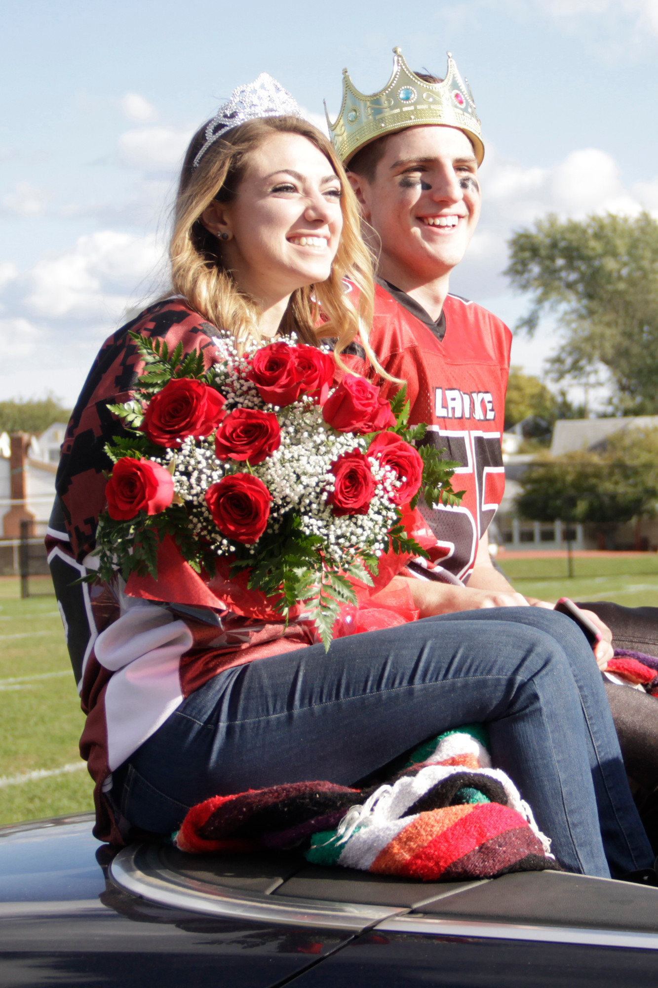 Homecoming Queen and King, Holly Romeo and Nick Normile, were all smiles atop their mobile throne.