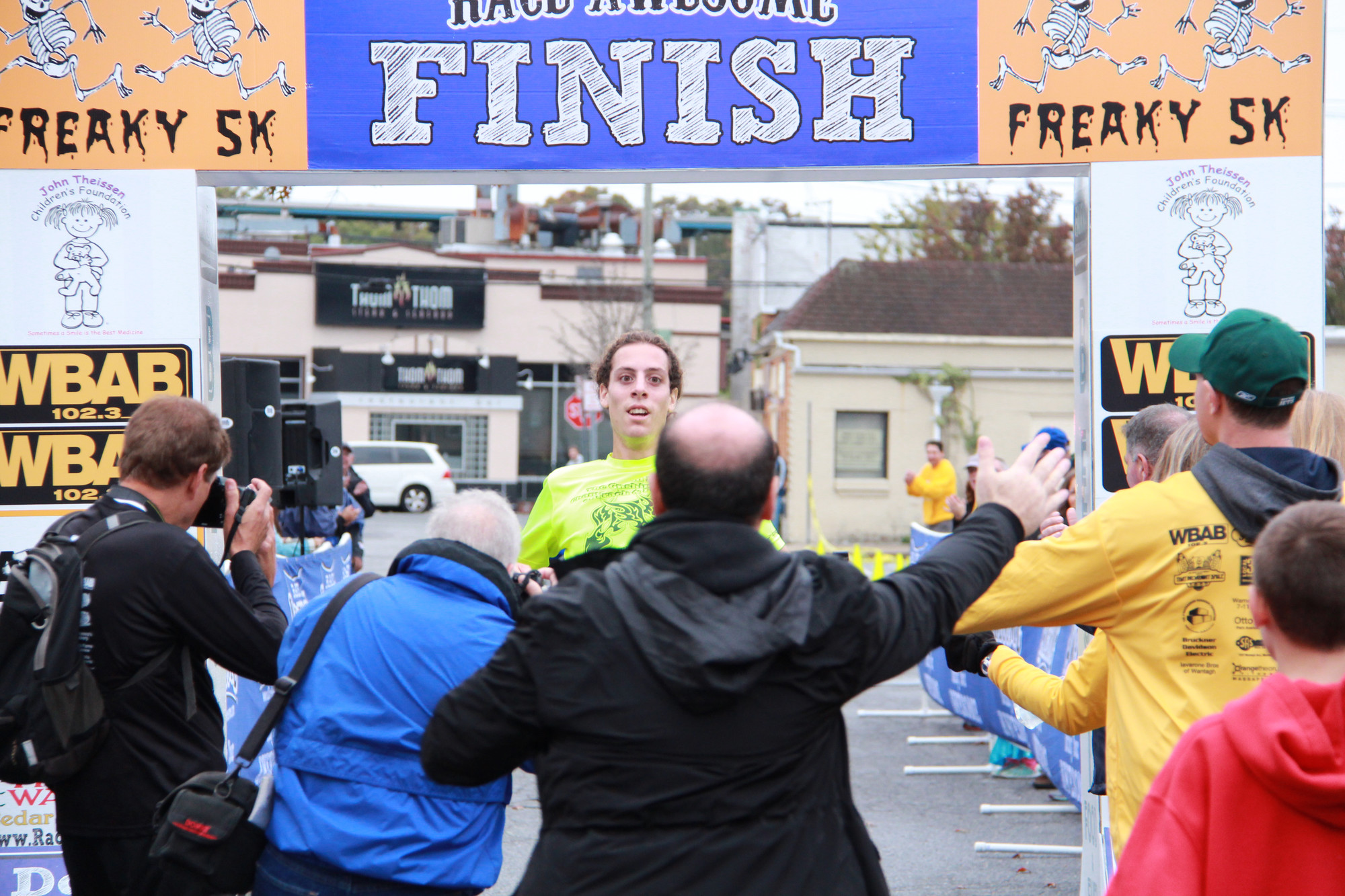 Everyone with a camera gathered to get a shot of Nick Filippazzo, of Wantagh, as he crossed the finish line. He was the top runner in the John Theissen Children’s Foundation’s Freaky 5K.