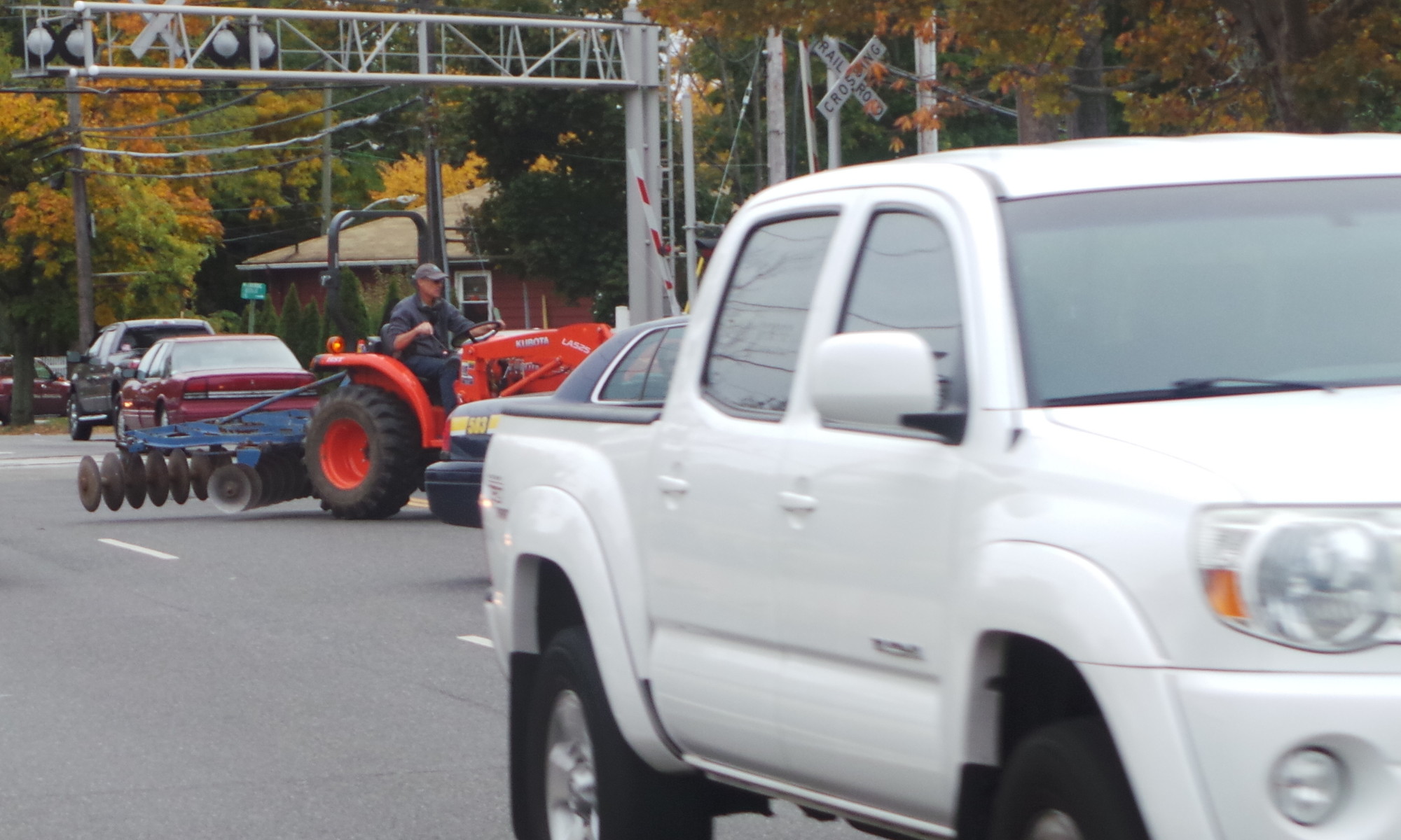 Rick White navigated Ocean Ave. traffic after returning from Malverne High School on the farm's tractor.