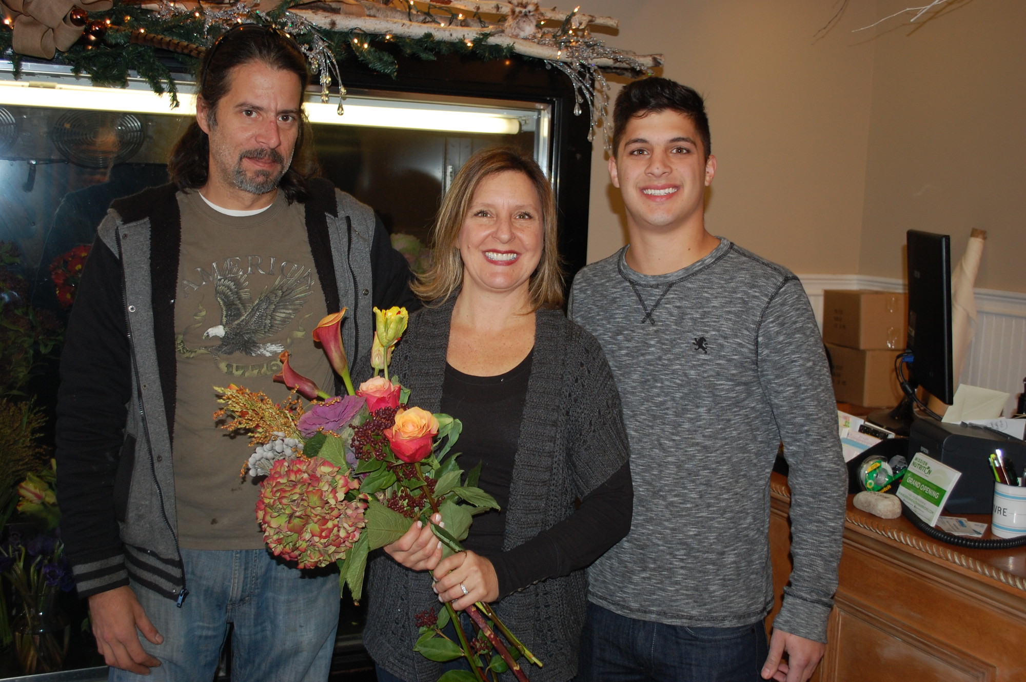 Floral designer Scott Reichle, left, is joined by Laura and Jake LaMontonaro who own the Flower Barn on Alken Avenue.