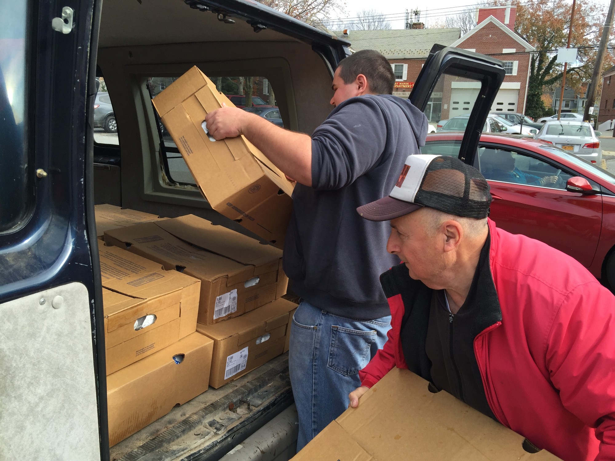 Joey Francavilla, left, and Danny Mirro picked up 64 frozen turkeys from the Key Food on Covert Avenue.