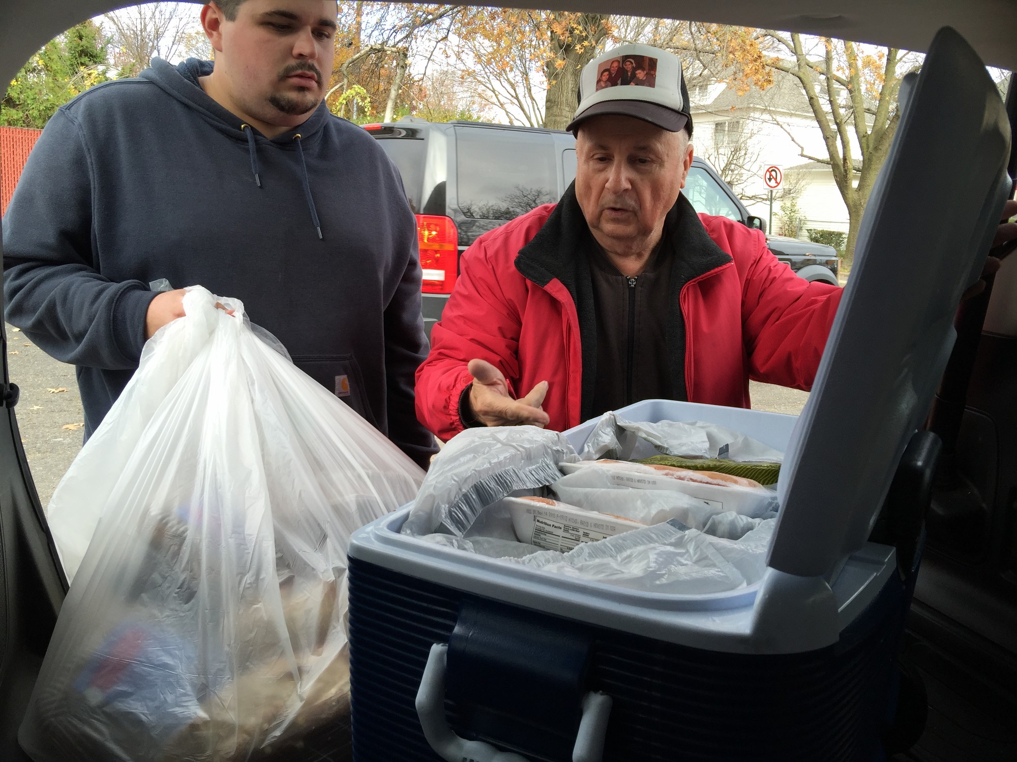 Joey Francavilla, left, and Danny Mirro picked up frozen food donated by Dr. Anthony Cordaro.