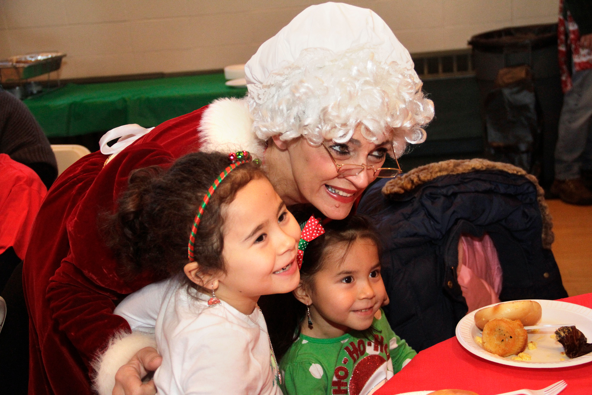 Mrs. Claus poses with Jasmine and Jada Leng at one of the village's three Breakfast with Santa events.