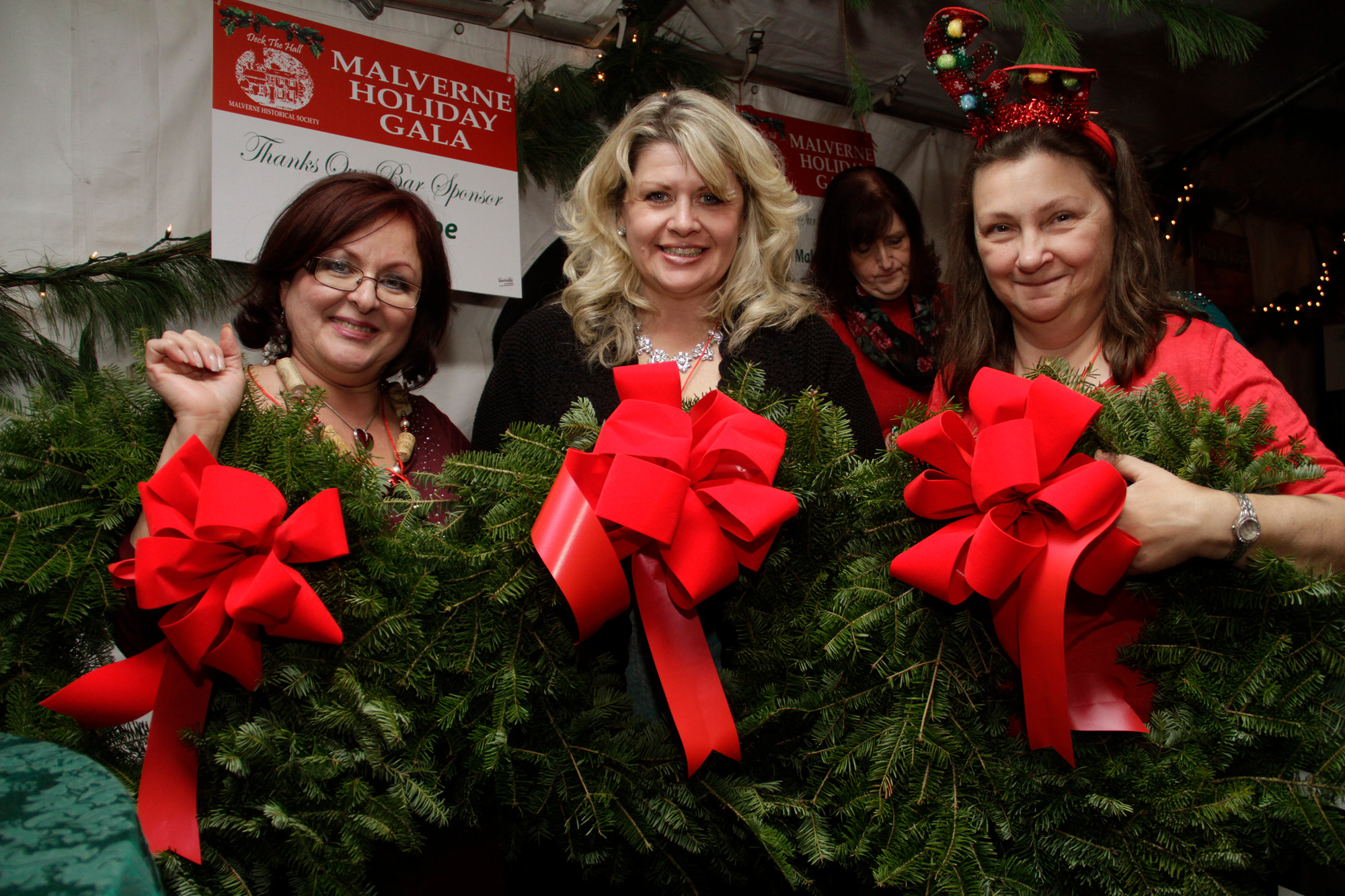 Liz Berger, Alison Lorch and Laurie Lerner, winners of a holiday wreath door prize at the Malverne Historical Society's Holiday Gala.