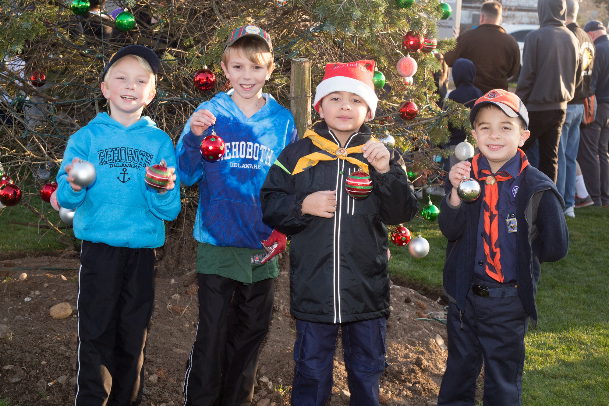 Cub Scouts from Pack 691 at Maria Regina School, from left, Drew Houck, Daniel Houck, David Monaco and Nicholas Ahrens helped decorate the tree at Triangle Park.