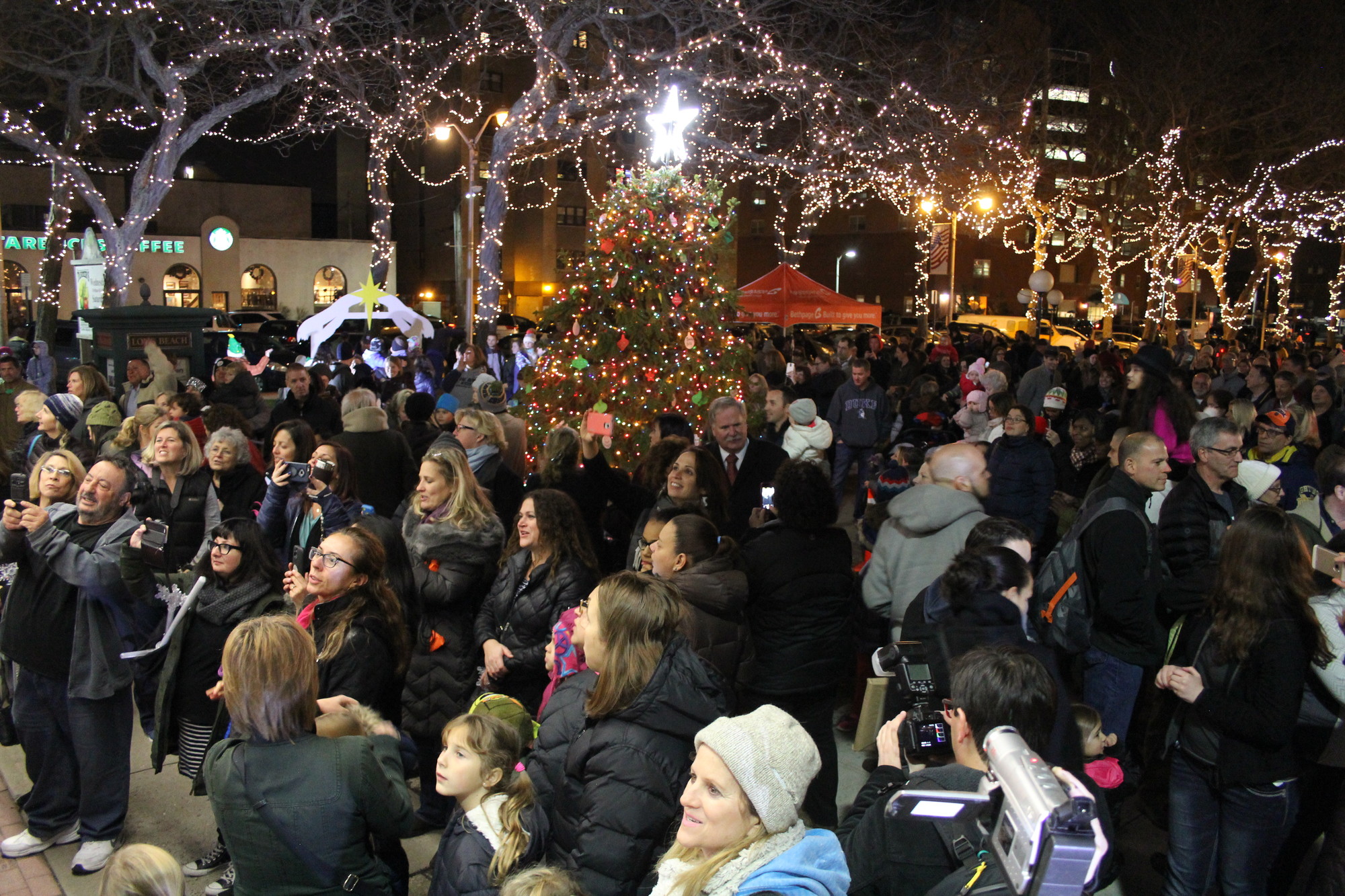Photos by Christina Daly/Herald
Hundreds crowded Kennedy Plaza last Friday for the city’s annual tree lighting ceremony, complete with an outdoor ice skating rink and a visit from Santa.
