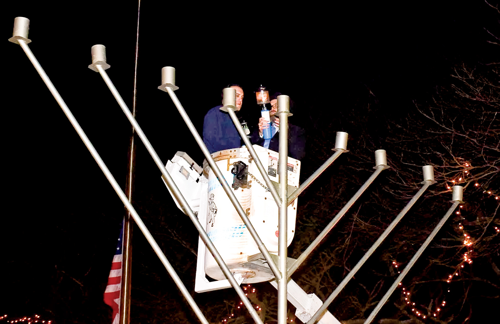Councilman Scott Mandell, left, lit the first candle of the menorah.