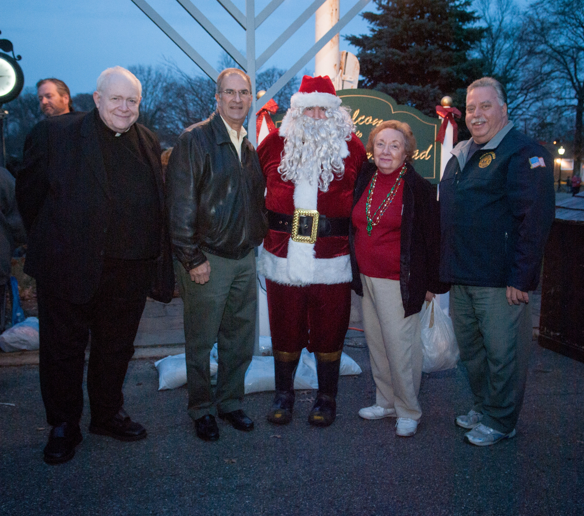 Monsignor Maniscalco of St. Thomas, Legislator Vincent T. Muscarella, W. Hempstead Civic Assoc. Chairperson Rosalie Norton and Frederick Senti, Former Chief of Lakeview Fire Department pose with Santa.