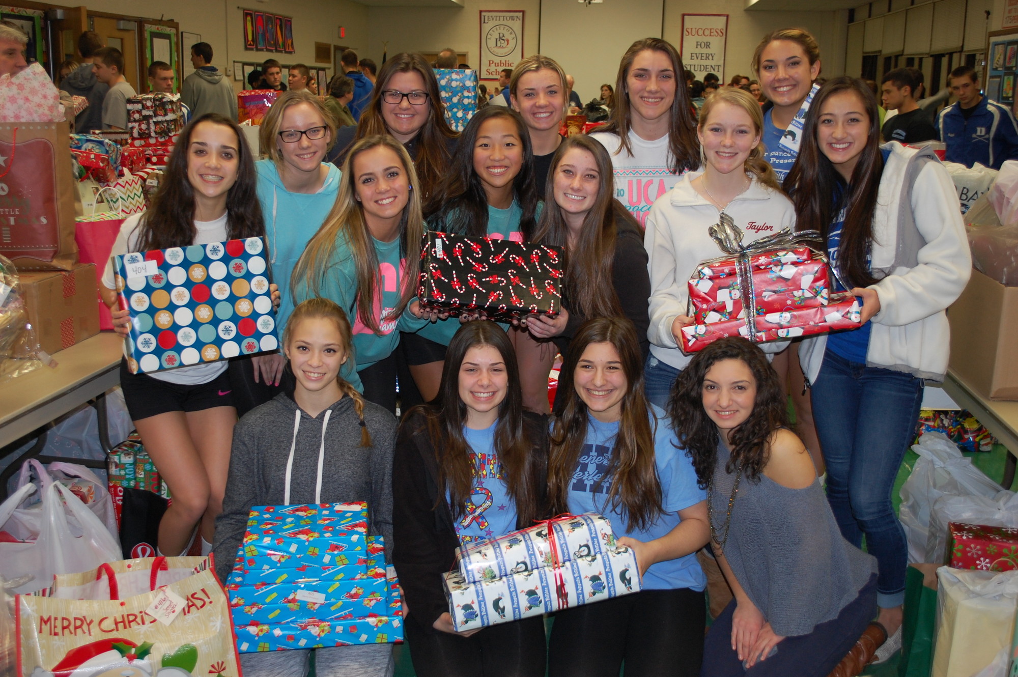 MacArthur High School Cheerleaders were among the volunteers who helped sort and wrap gifts for Levittown’s Adopt-A-Family program.