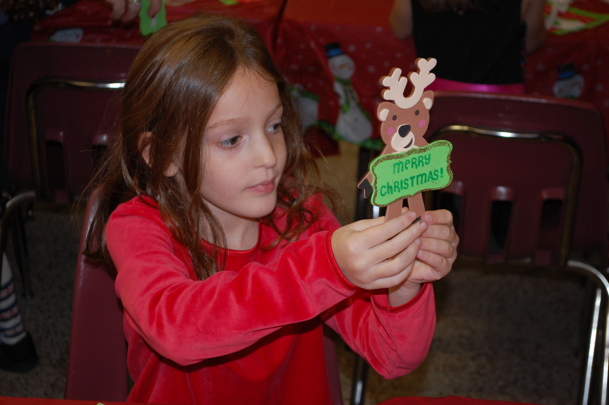 First-grader Shannon Watt proudly showed off the reindeer ornament that she made to take home for her Christmas tree.