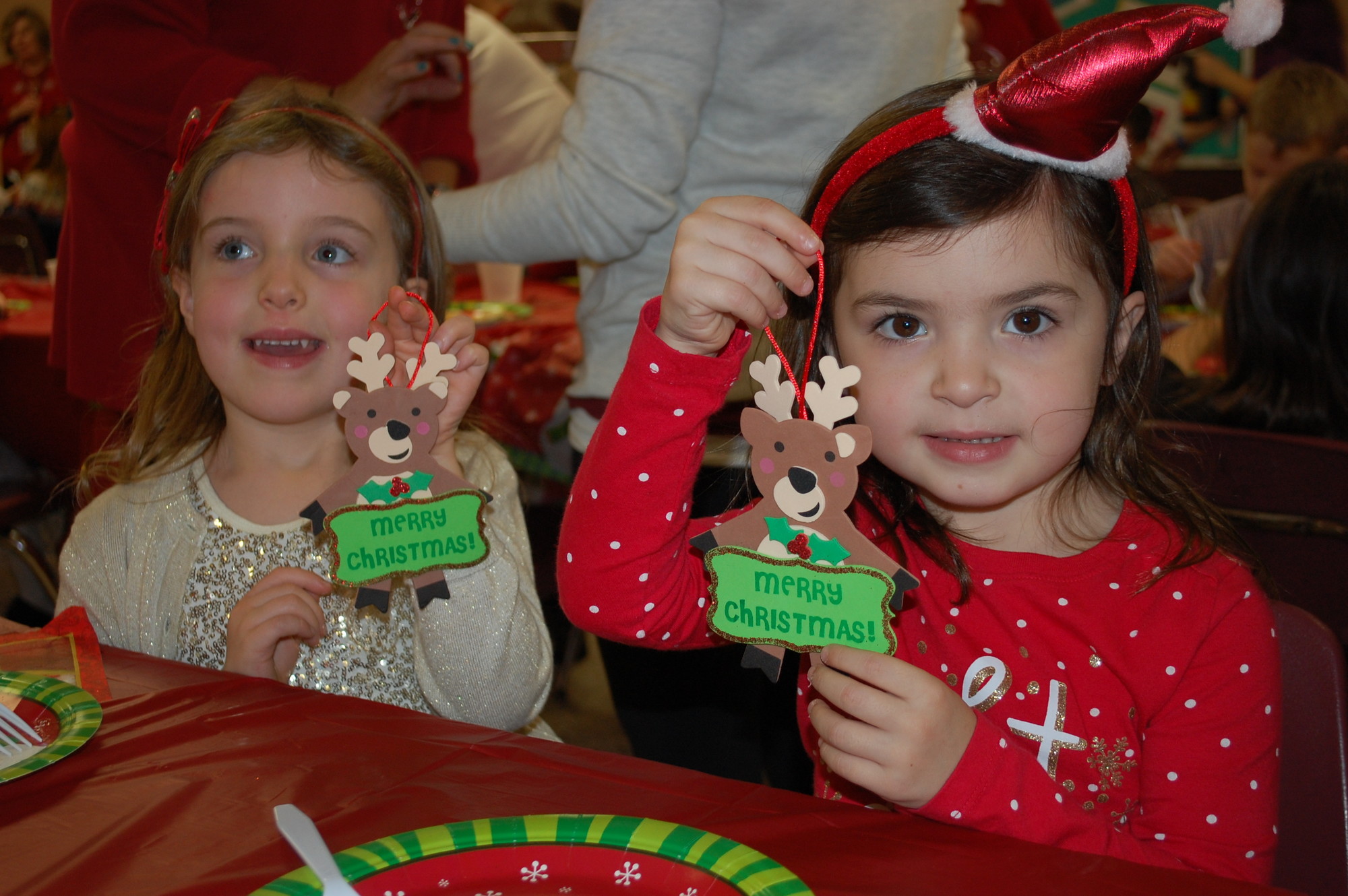 Kindergartners Olivia Gallagher, left, and Hannah Masi displayed their finished crafts.