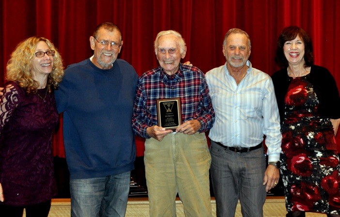 Valley Stream resident Bill Benson, center, was congratulated by, from left, the Greater Long Island Running Club’s vice president, Mindy Davidson, President Mike Polansky, Vice President Carl Grossbard and Executive Director Linda Ottaviano.