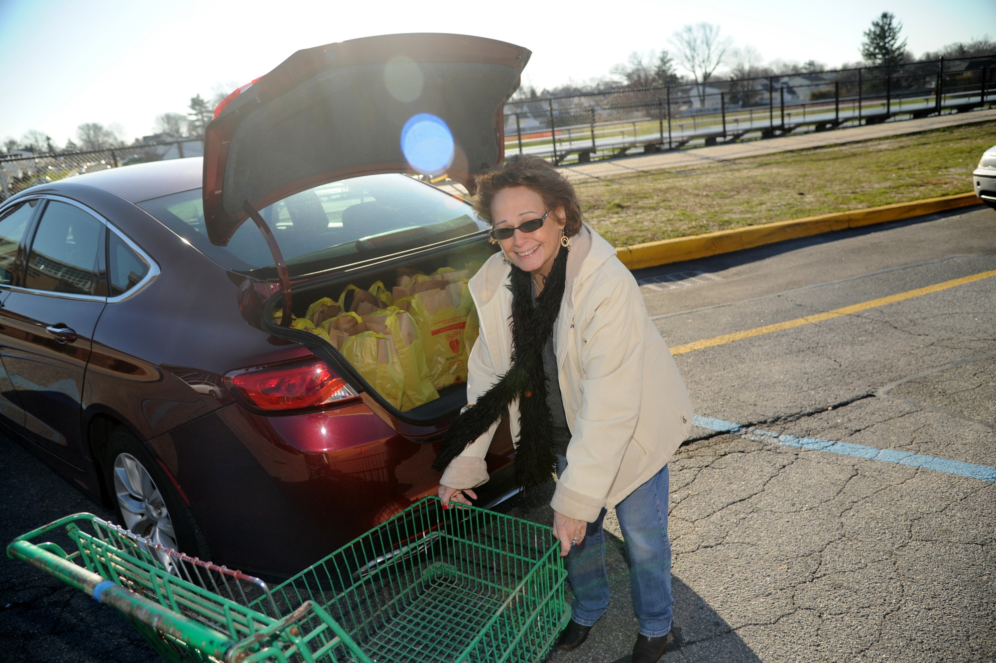 Elizabeth Fries happily packed her car with donations for the needy.